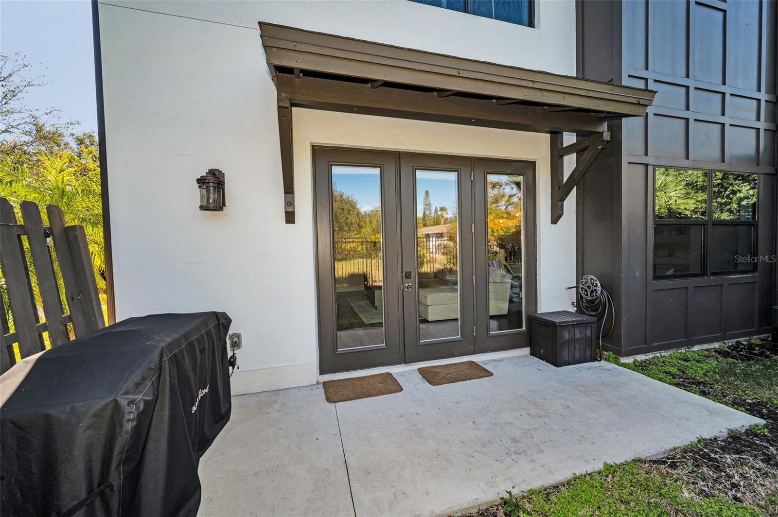 Rear private patio and fenced yard w/ French doors