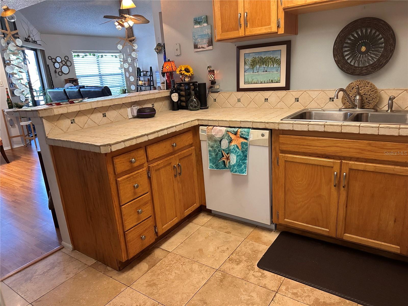 Lots of Cabinets and Pretty Tile Countertops.