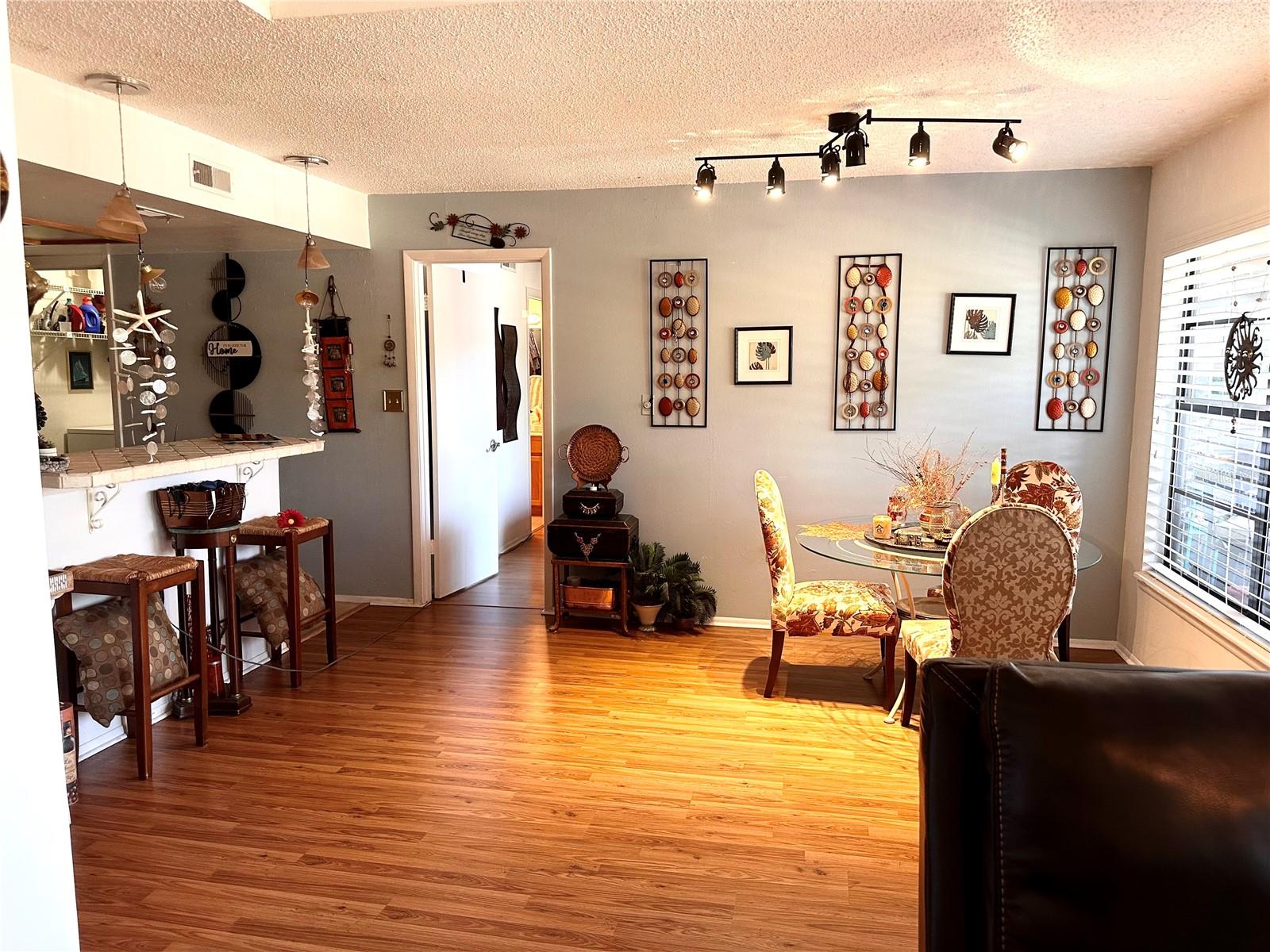 Breakfast bar opens to Kitchen.  Love the flooring.