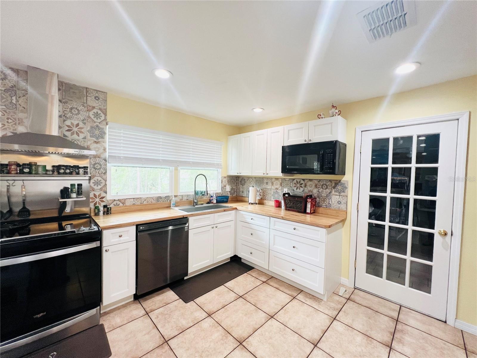 VIEW OF KITCHEN SHOWING DOOR TO LAUNDRY ROOM AND STORAGE ROOM