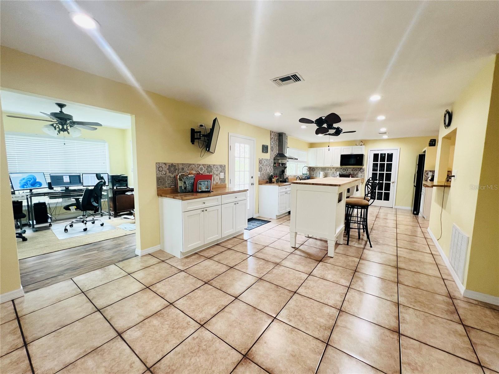 VIEW FROM BREAKFAST AREA SHOWING THE FLORIDA ROOM AND DOOR TO ACCESS OUTSIDE BACK YARD