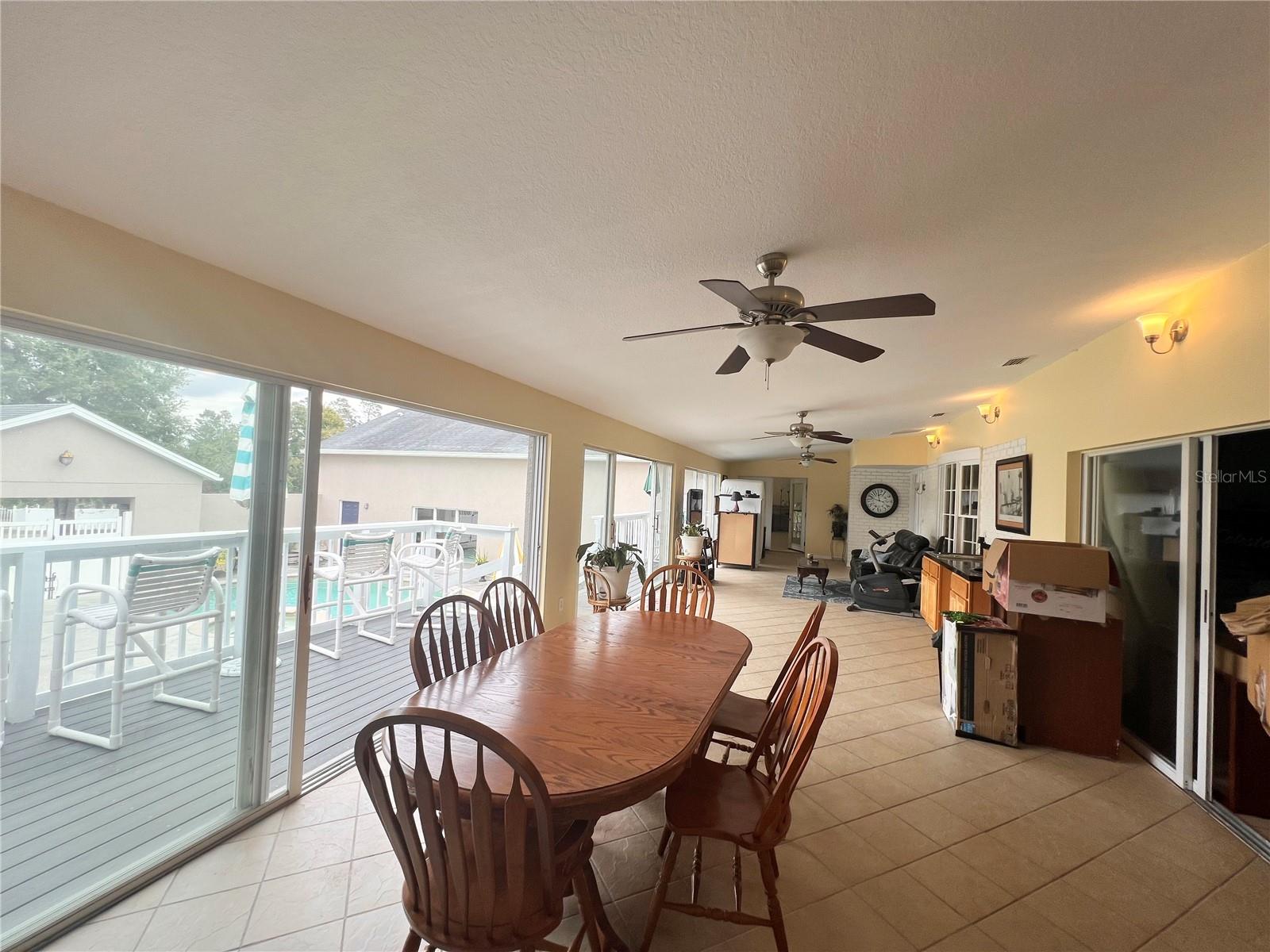 LIVING AND DINING ROOM WITH WET BAR SLIDING DOORS TO OUTSIDE AND INSIDE