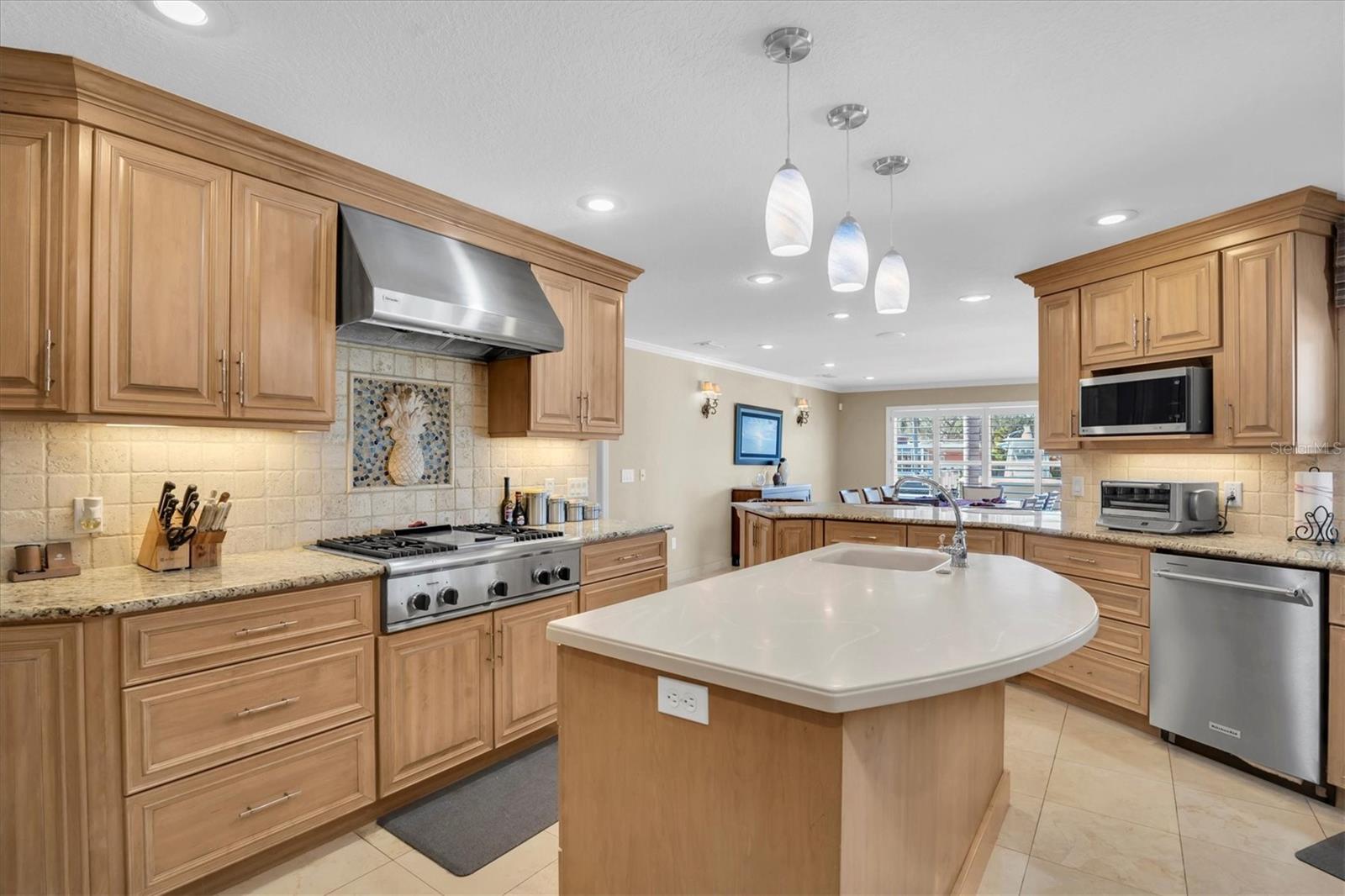 Kitchen made for cooks with large island, center sink with water filter