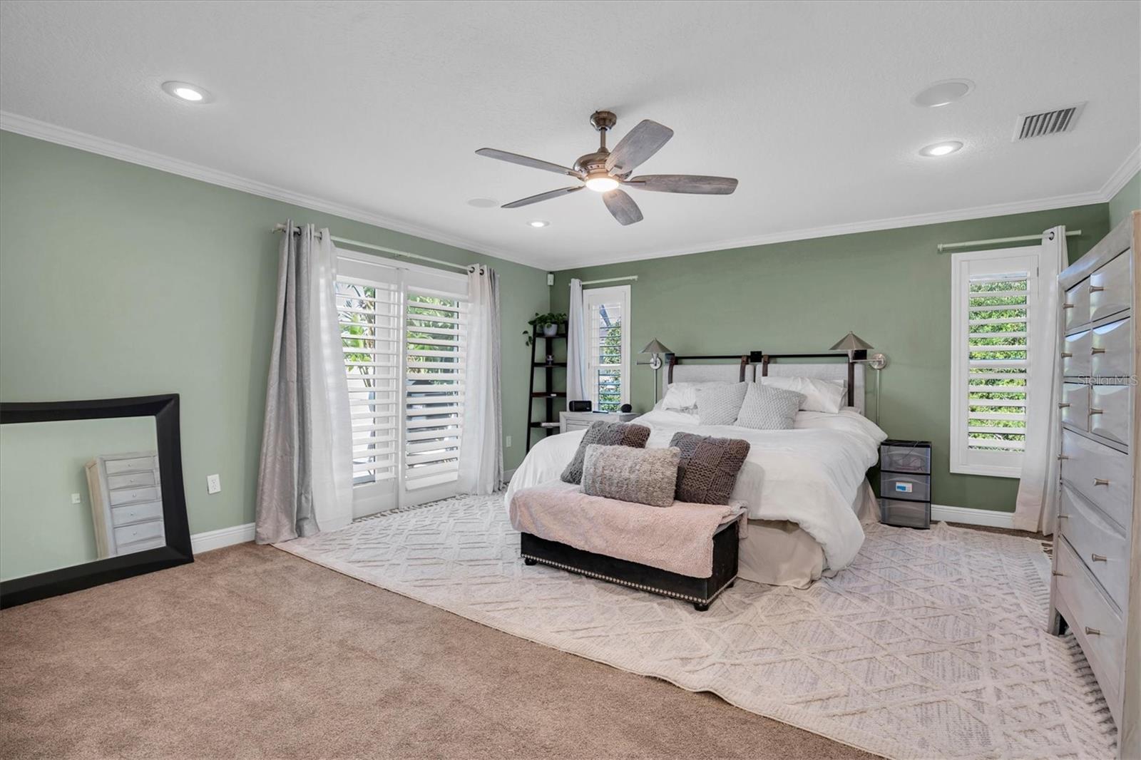 Primary bedroom with sliders to patio and pool