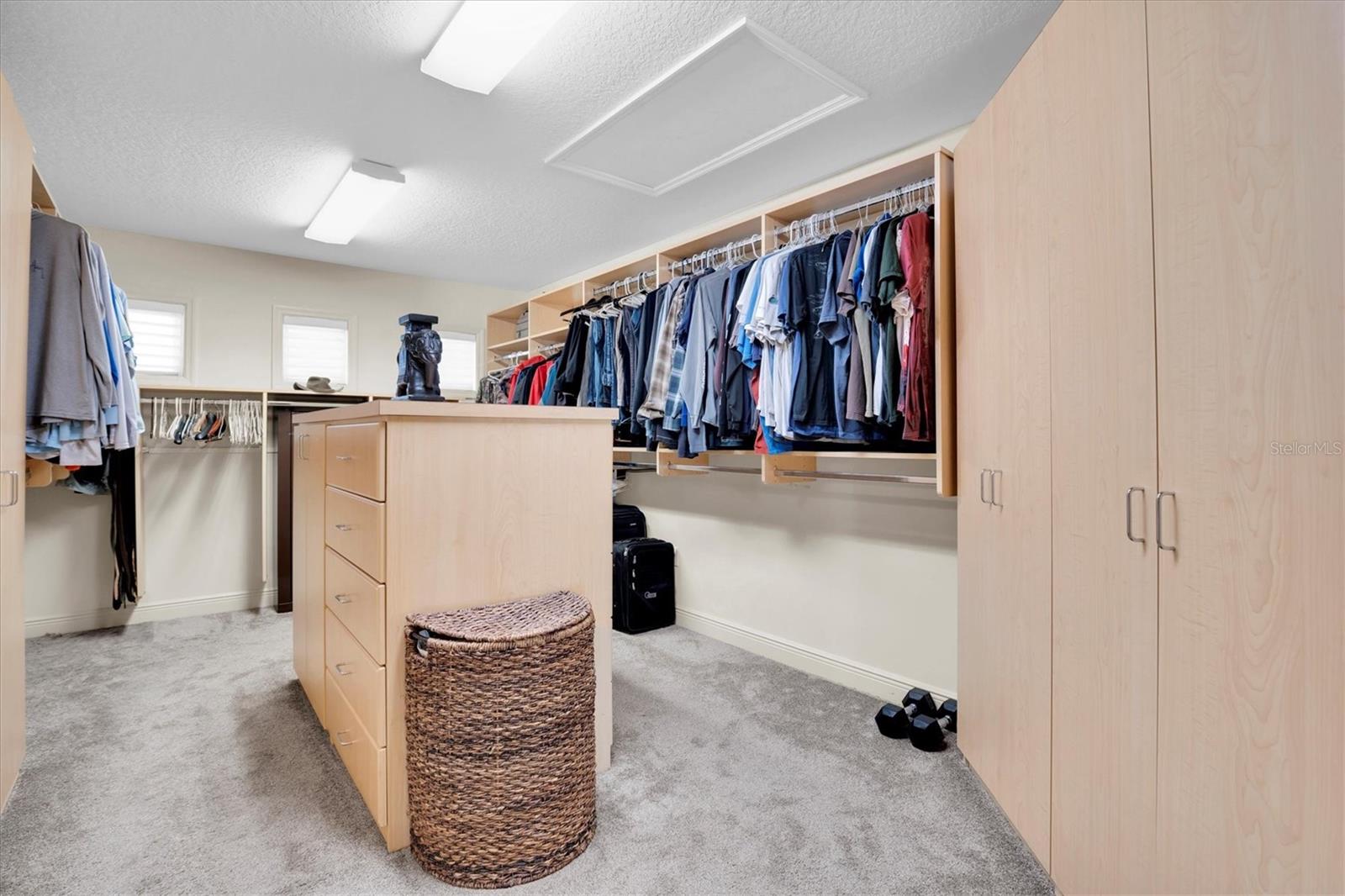 large walk in closet with island