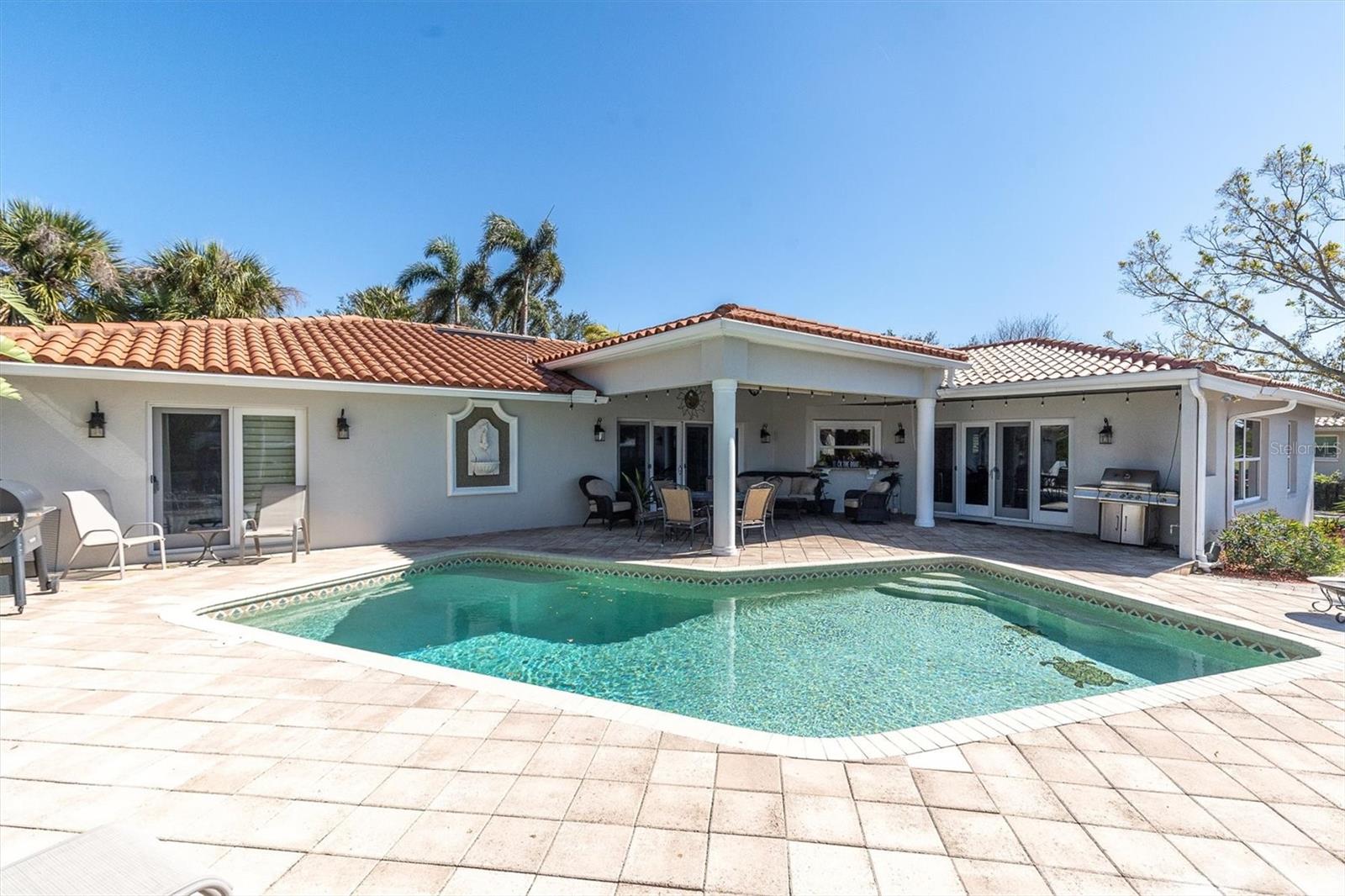 Paver patio surrounding heated swimming pool