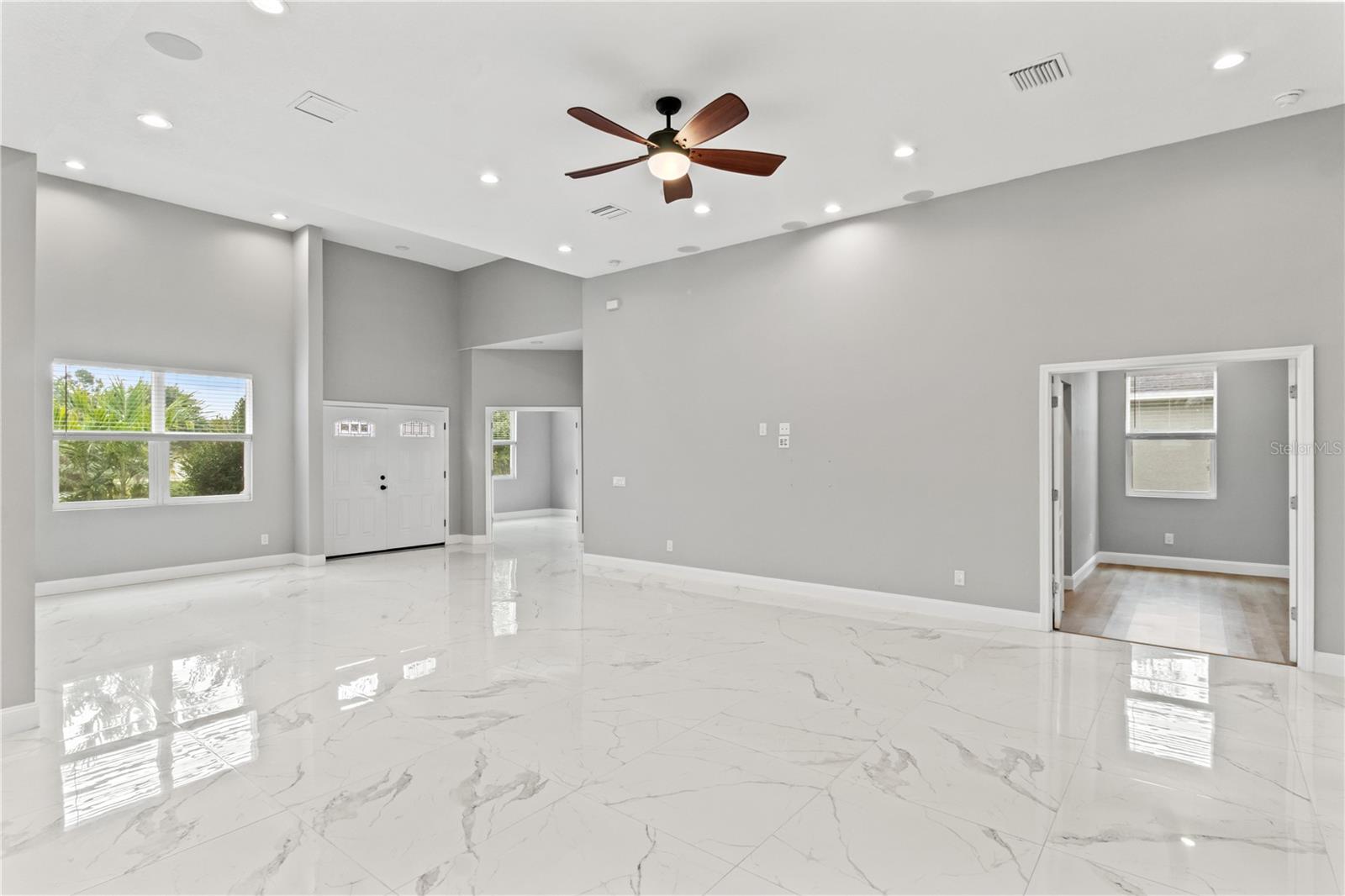 view of dining room/front door entrance/guest room and entrance on right to the primary bedroom