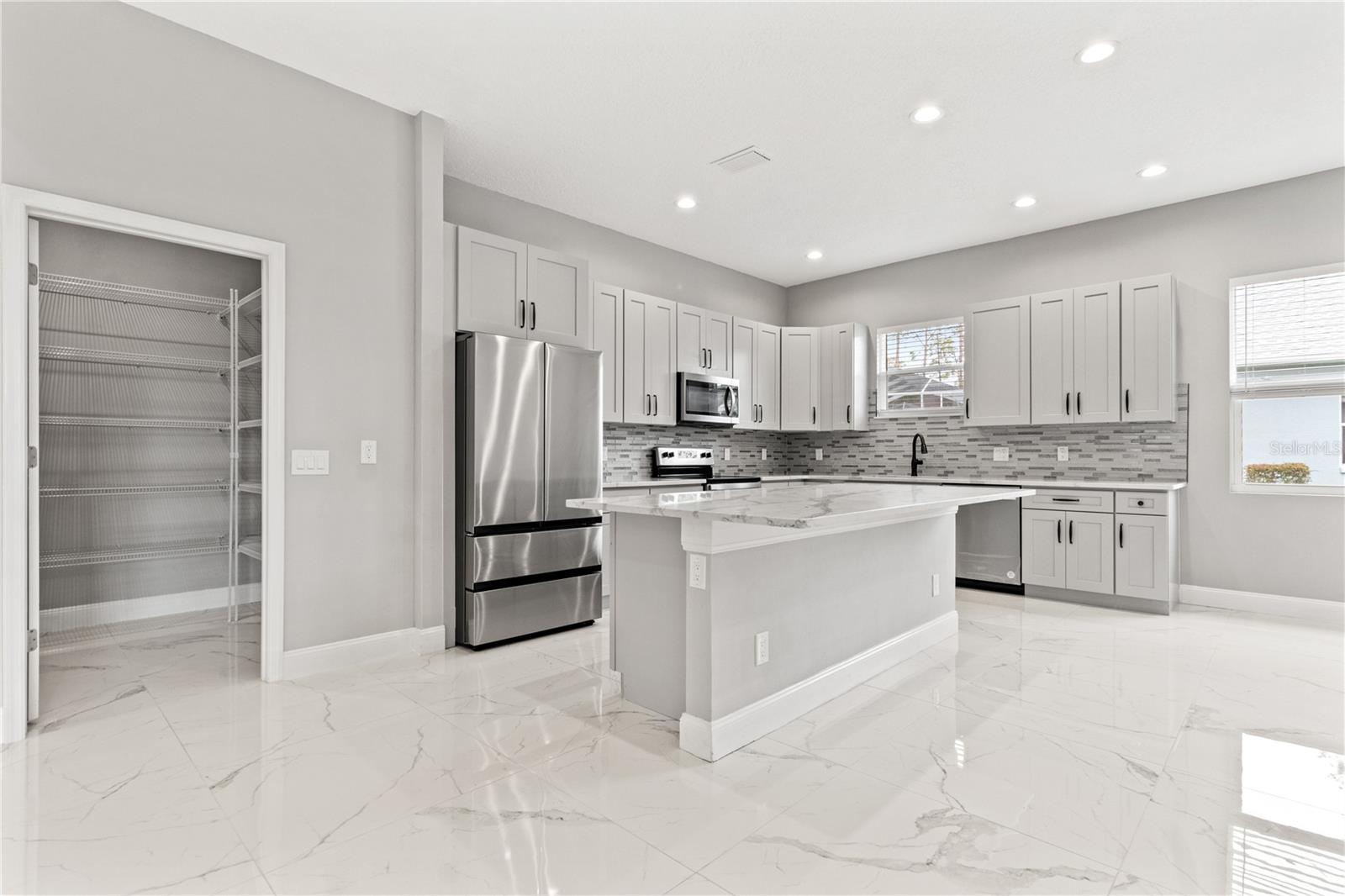 Kitchen view 1 -island and large pantry