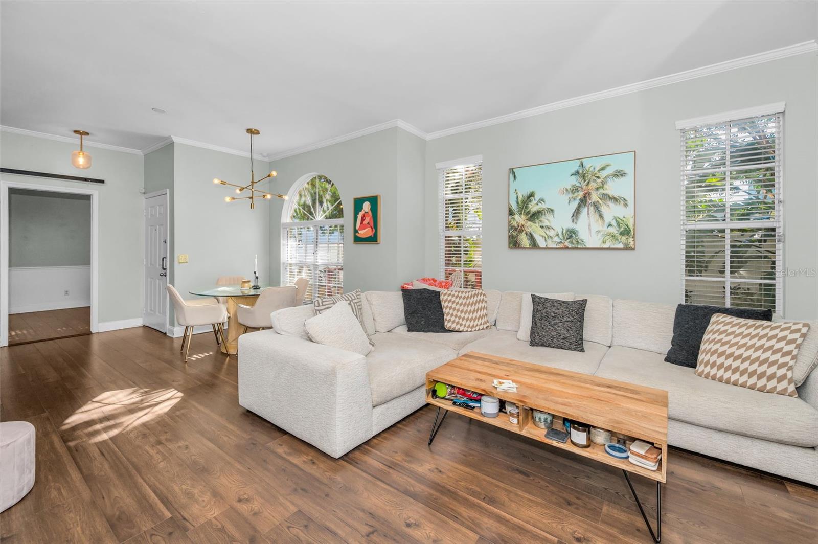 VIEW OF LIVINGROOM TOWARDS DINING AREA , FRONT DOOR AND KITCHEN