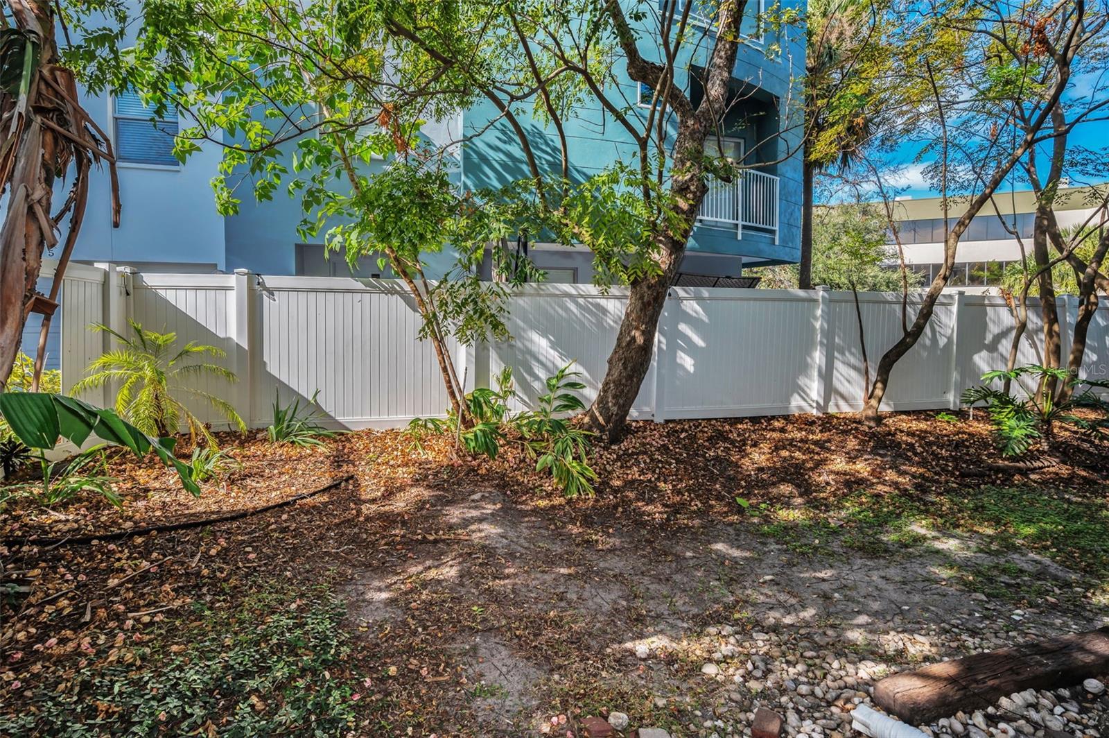 COMMUNITY AREA BEHIND CONDO WITH PRIVACY FENCE