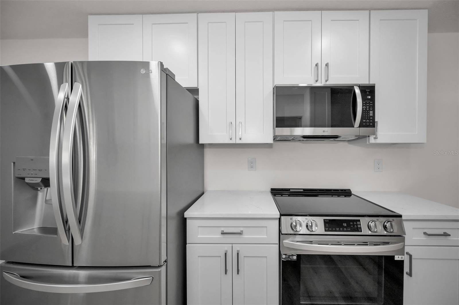 New Stainless Steel Refrigerator, Microwave, and Range Appliances