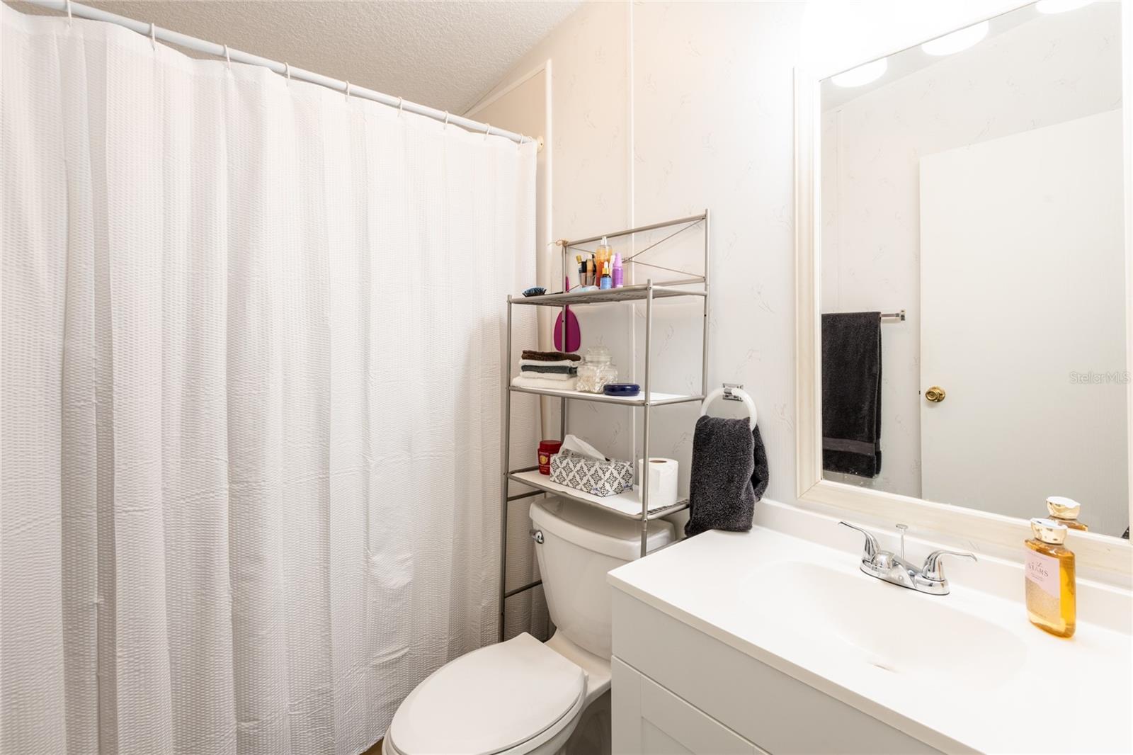 Guest bathroom with tub/shower.