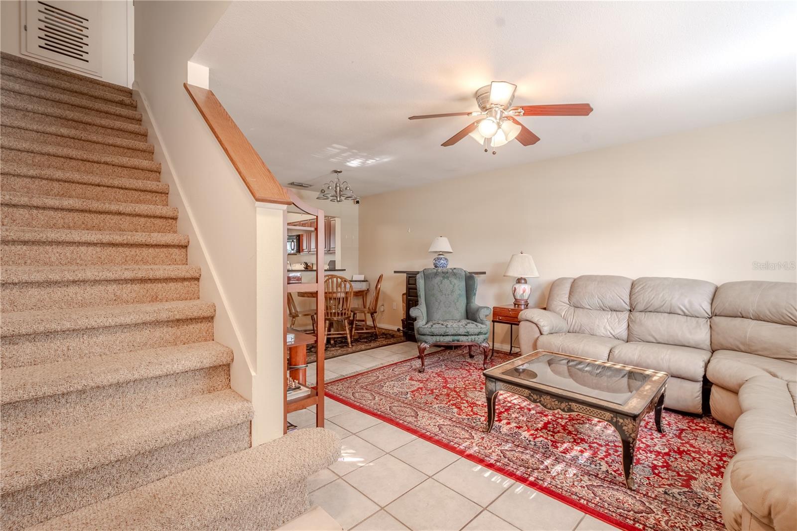 Carpeted stairs lead upstairs