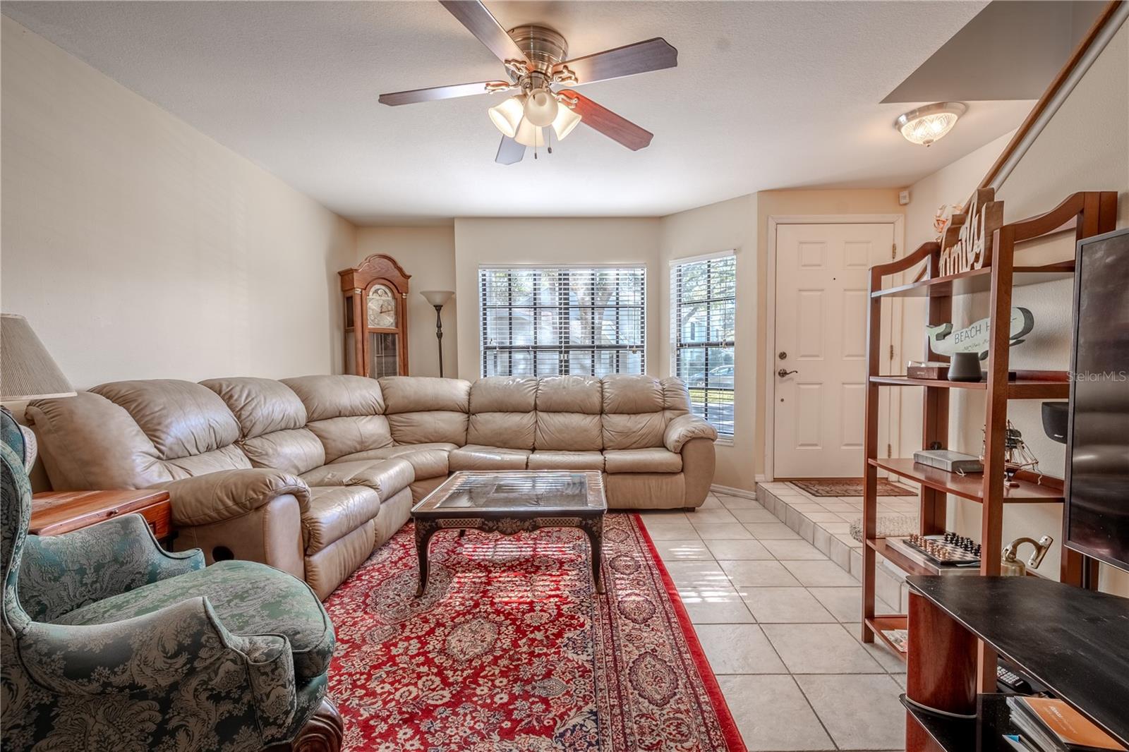 The spacious living room features a bay window.