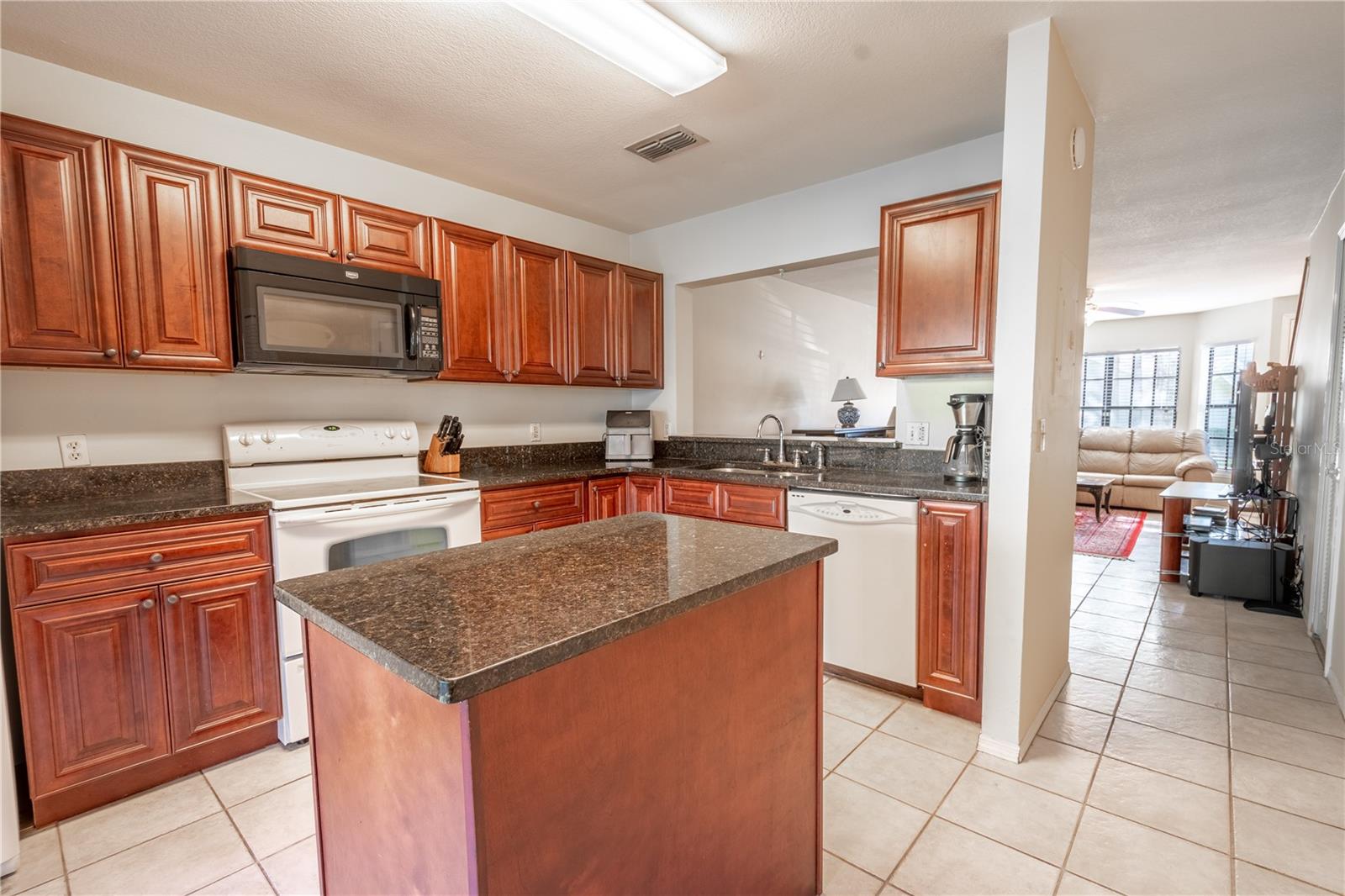 ou’ve got soft-close wood cabinets, granite counters, and a great island that adds more storage and prep space. The appliances (range, refrigerator, dishwasher, and microwave)