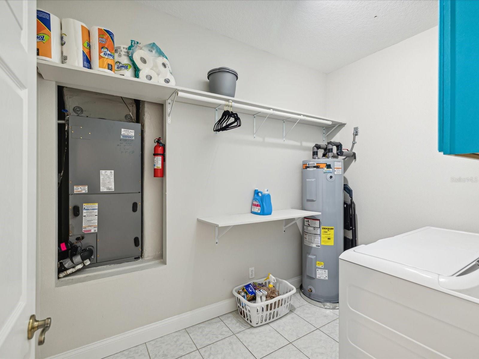 Laundry room with built in cabinets and shelving