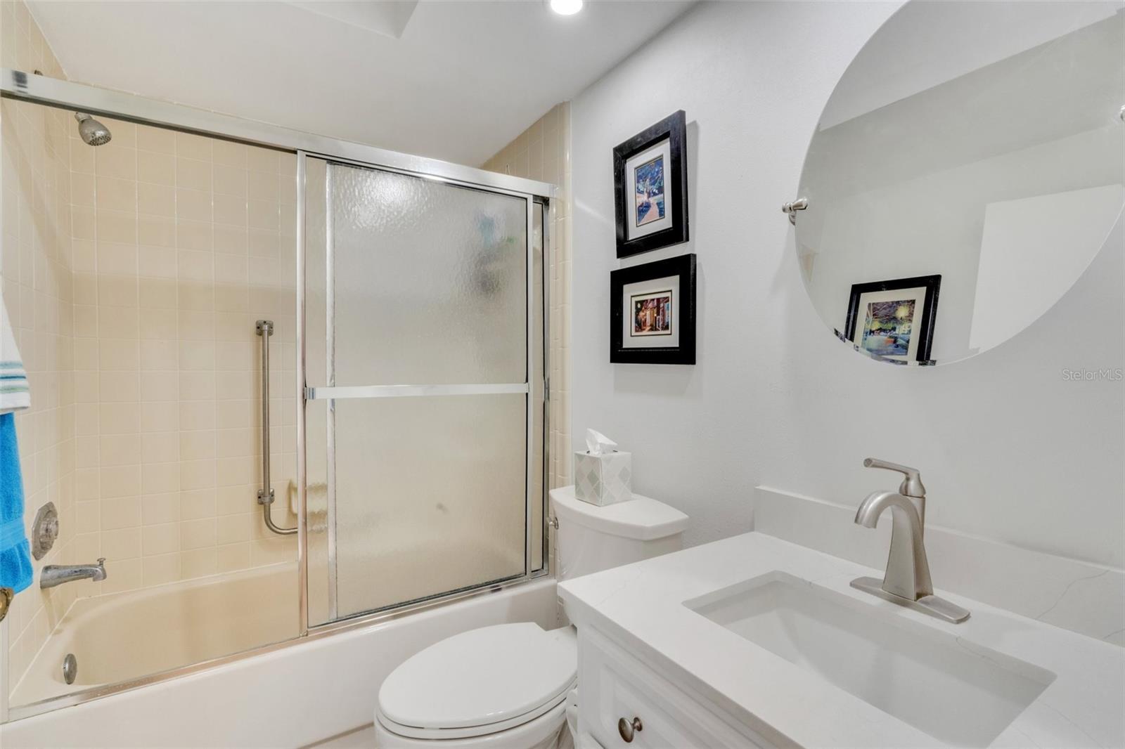 Updated hall bath located between guest suite & main living with tub/shower combo~