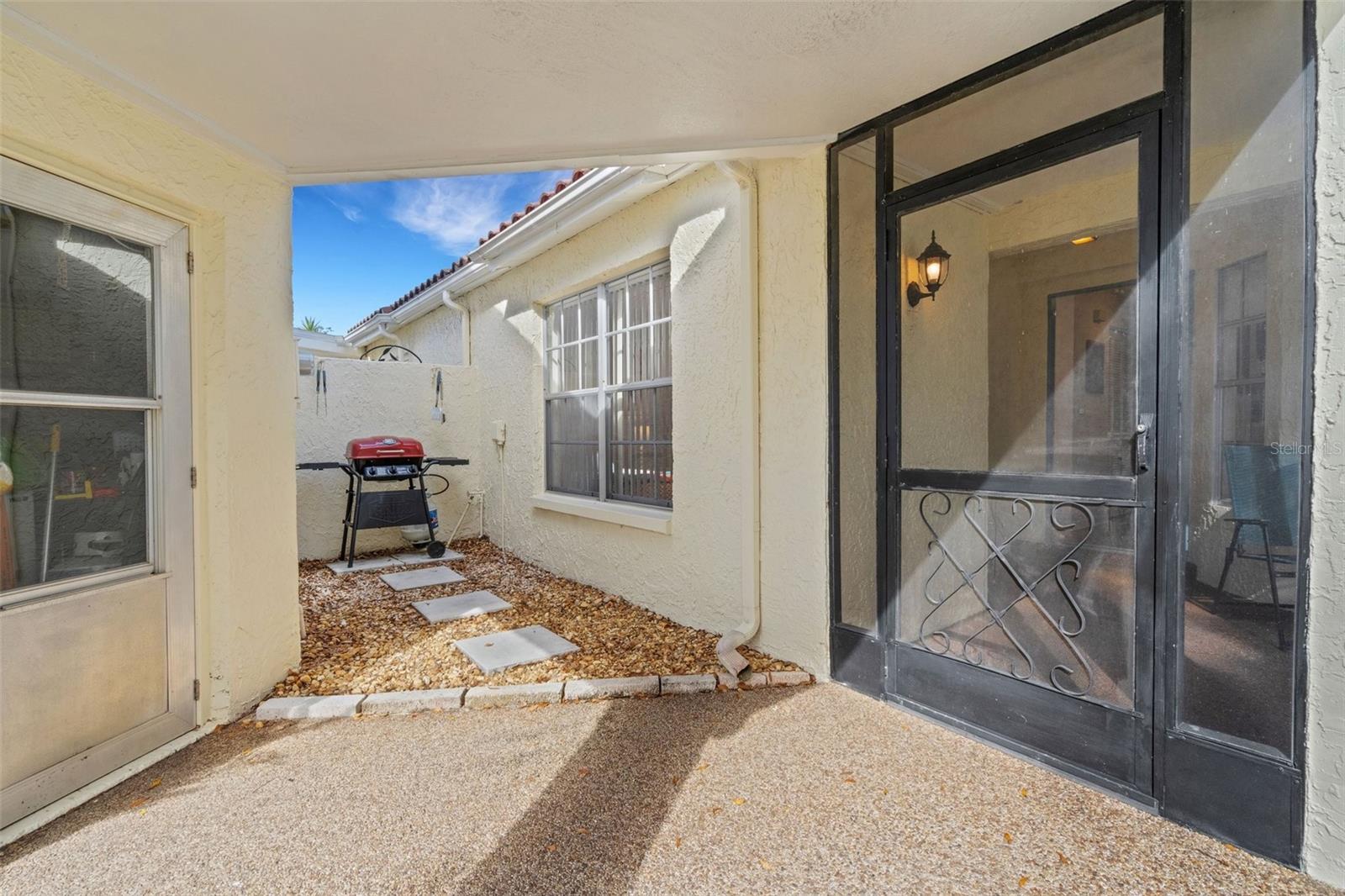 Covered walkway to oversized garage with room for vehicle & golf cart. Cart may also be parked in hidden nook between garage & villa~