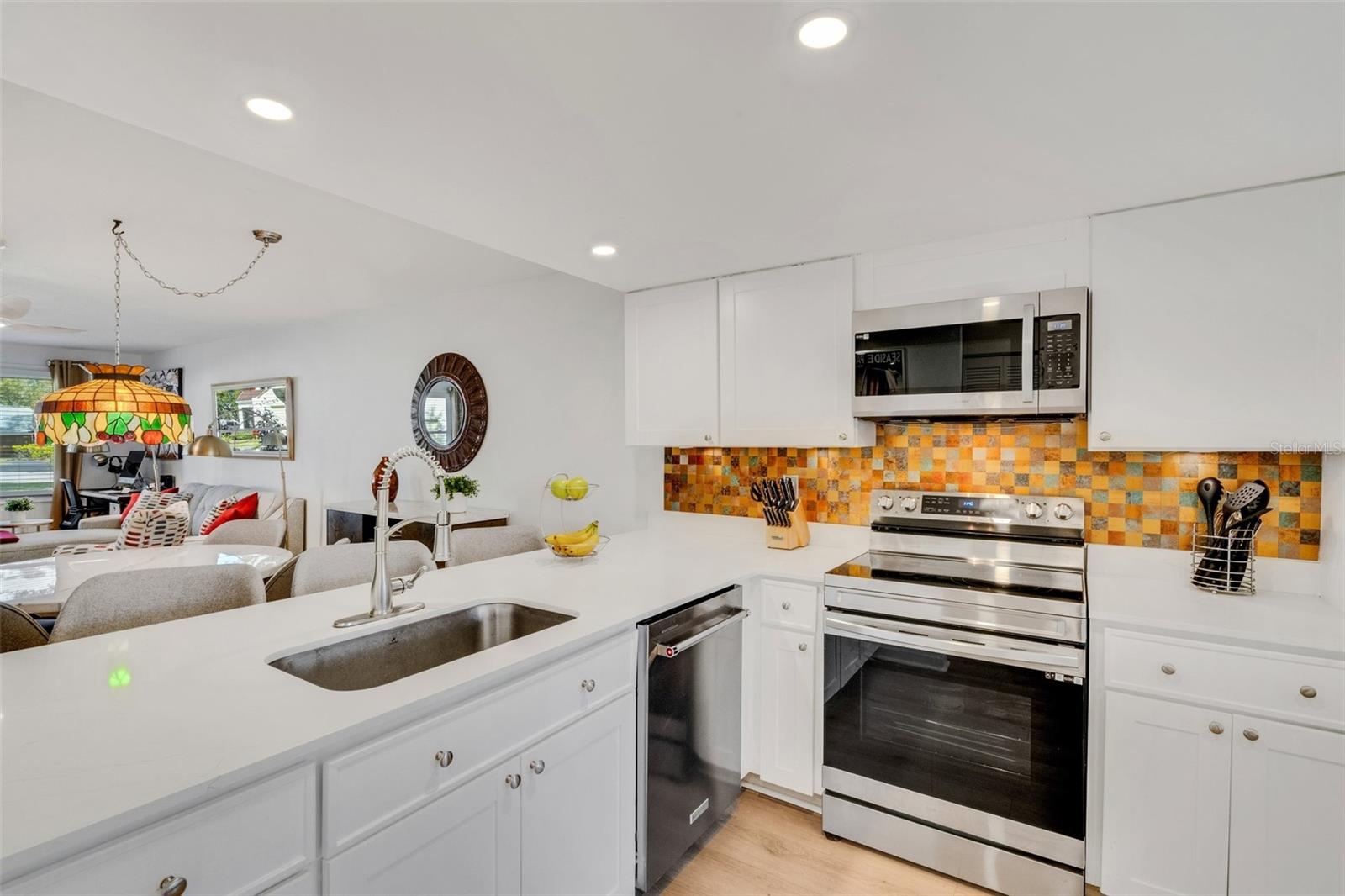 Beautifully updated kitchen with quartz countertops, solid-wood cabinetry, & recessed lighting~