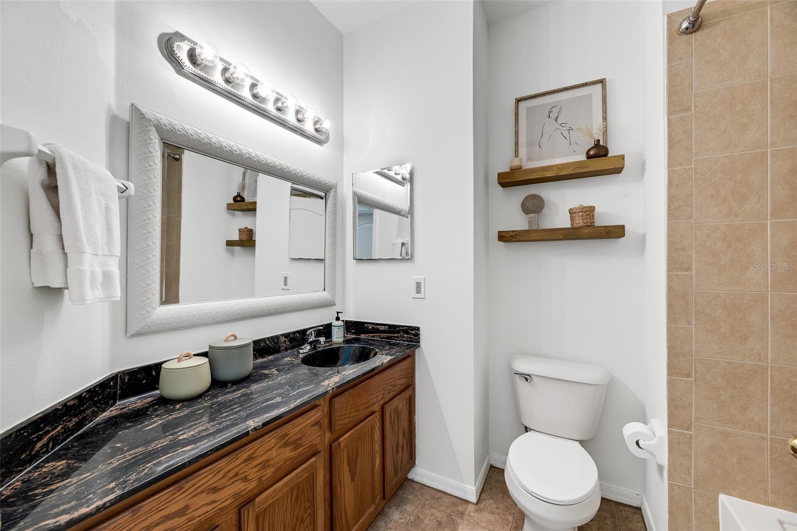 The guest bathroom has a tub/shower combination.