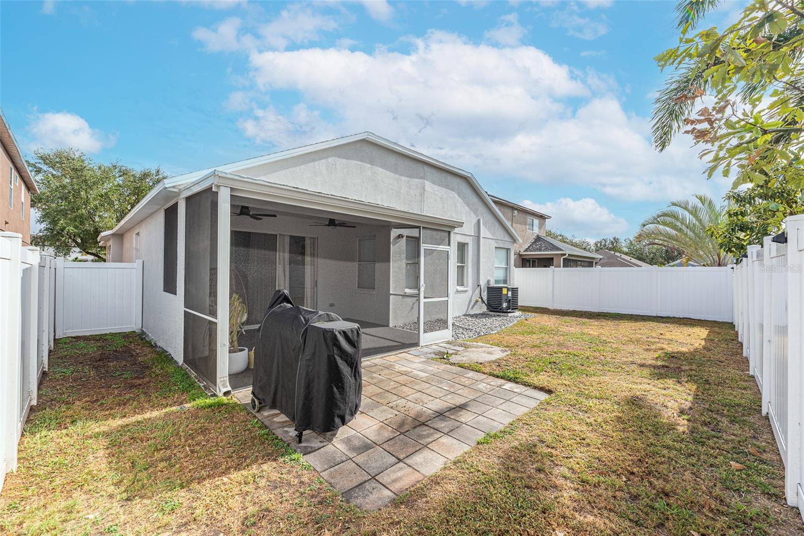 Relax and unwind on your extended lanai, where you can enjoy outdoor dining or a barbecue on the pavered patio, all within the privacy of your fenced backyard.