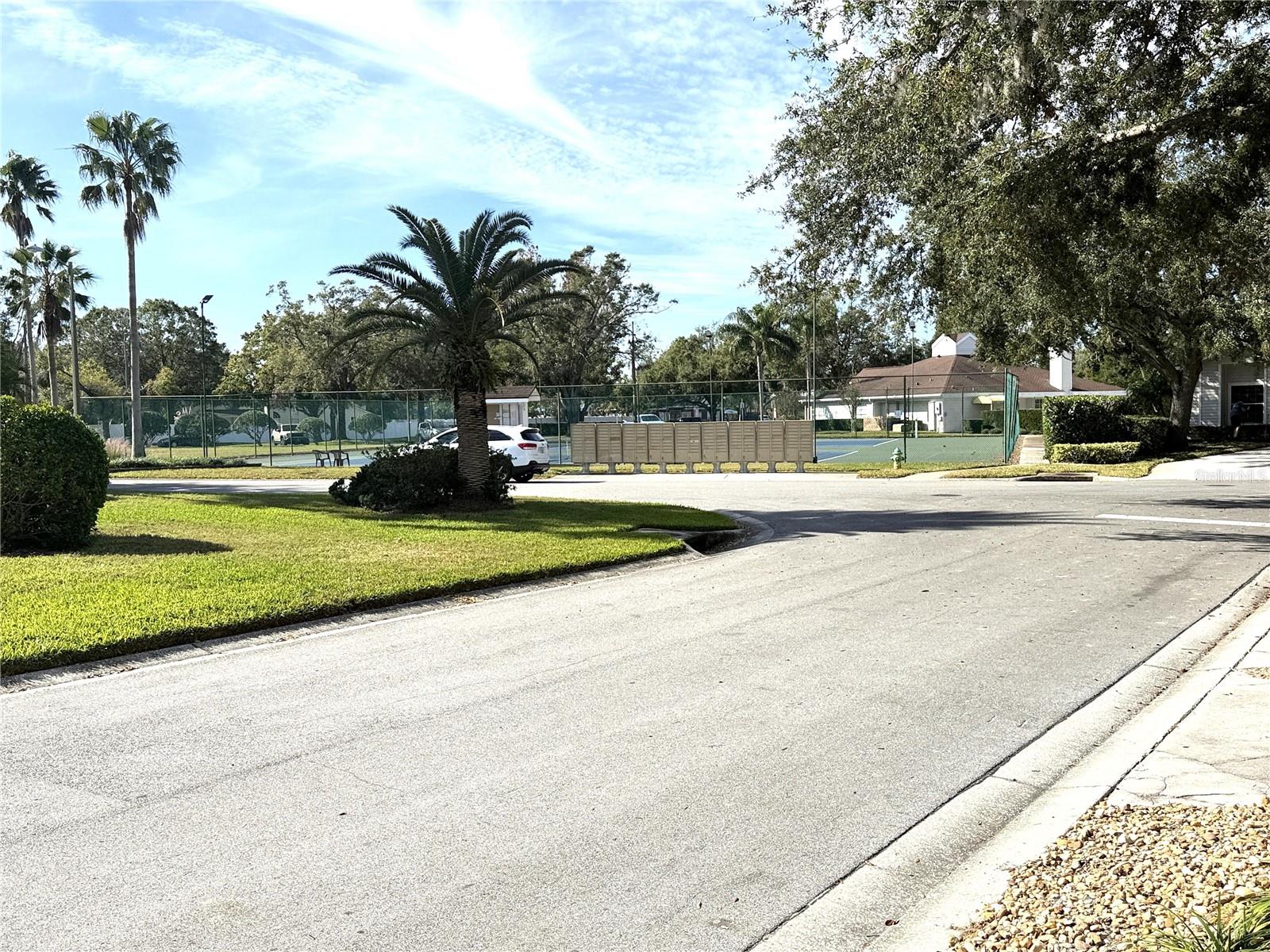 close by mailboxes, tennis courts and clubhouse/pool