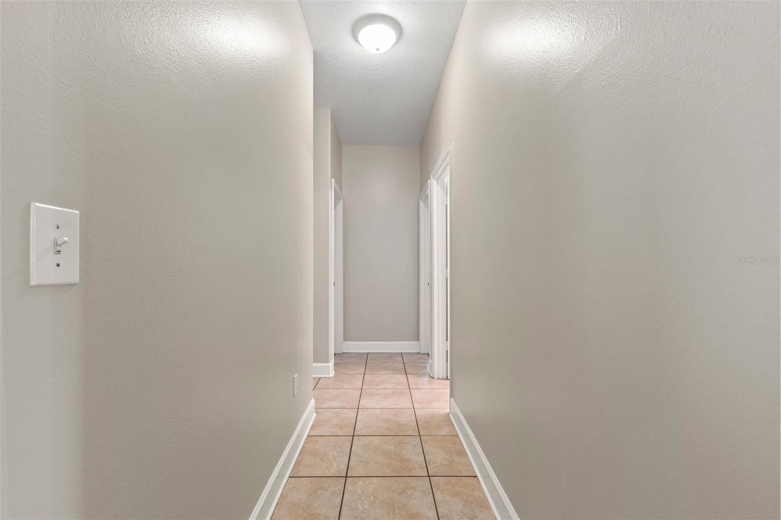 Hallway leading to other bedrooms and bathroom