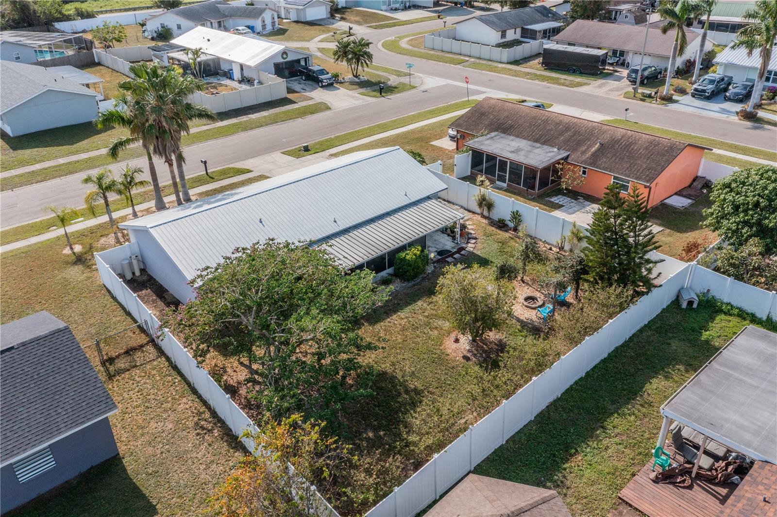 DRONE VIEW OF FENCED BACK YARD AND HOME