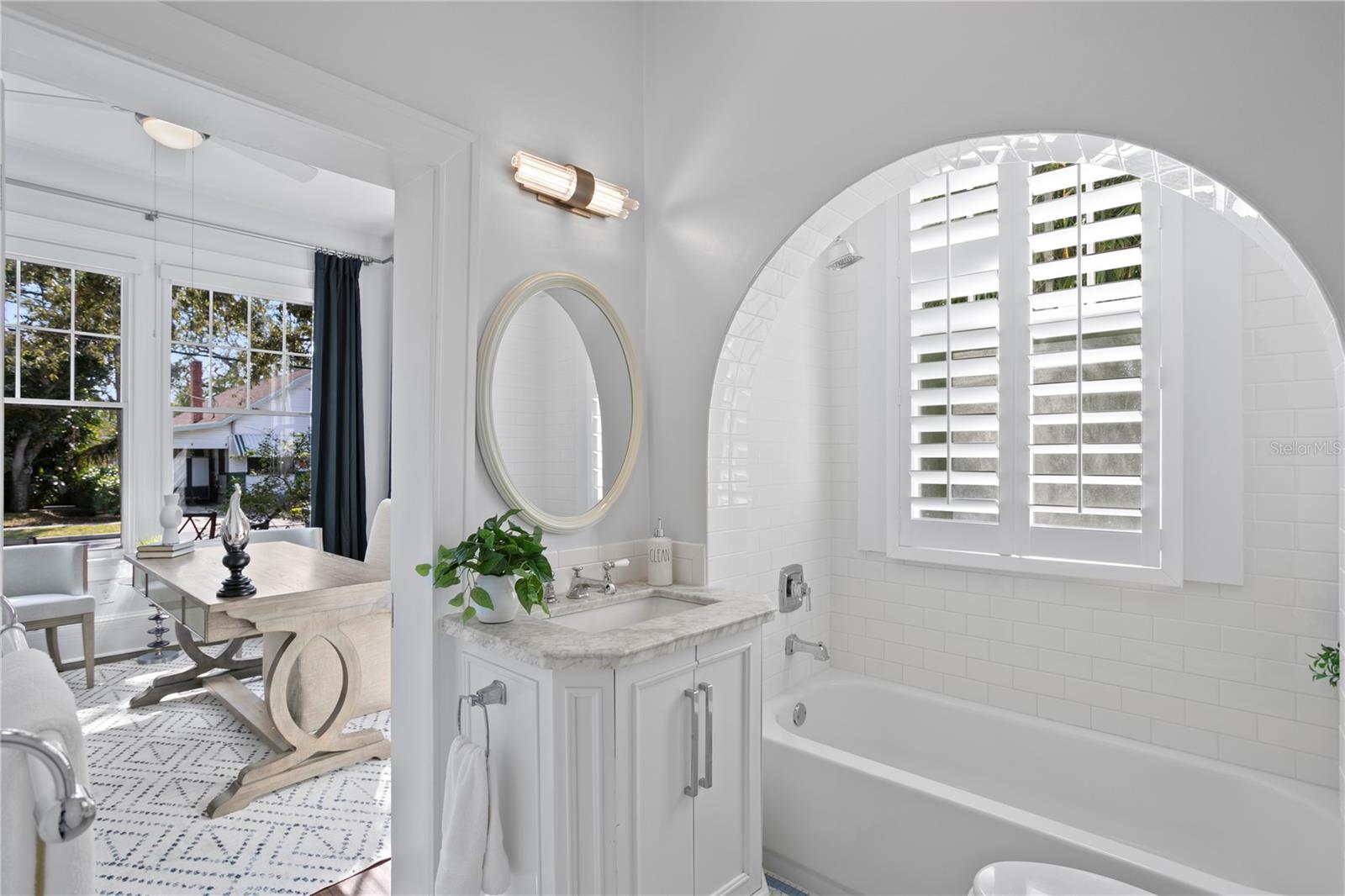 Charming hall bath with period tub/shower combination.