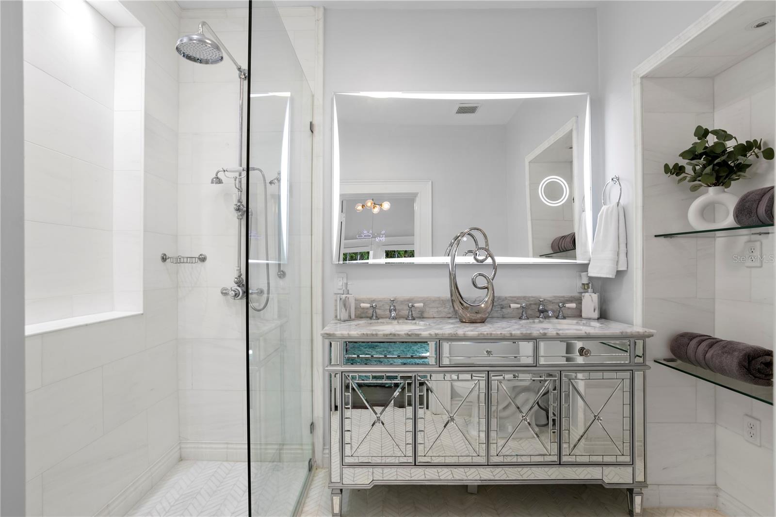 Primary bath finished in gorgeous marble with an expanded shower.