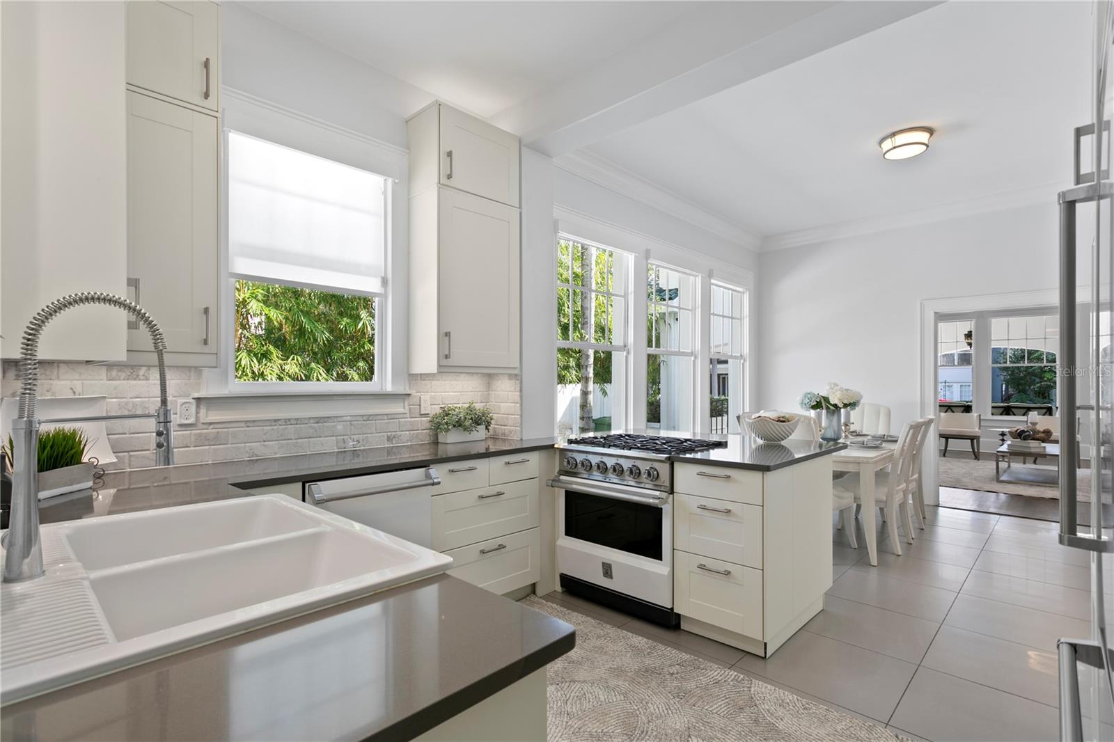 The open concept floor plan provides loads of natural light that illuminates the entire home, together with beautiful lighting fixtures, beautiful crown molding and gleaming espresso oak wood floors.