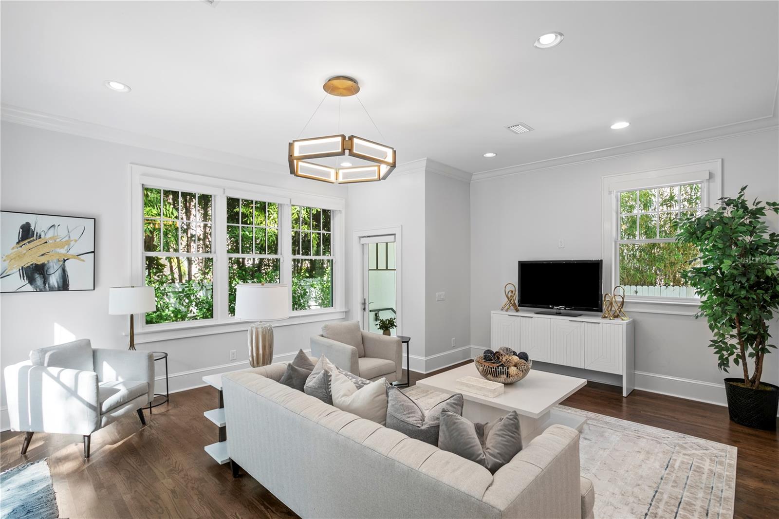 The newer portion of the home includes the family room and loads of upgraded impact rated windows and doors and views of grandfather oaks throughout.