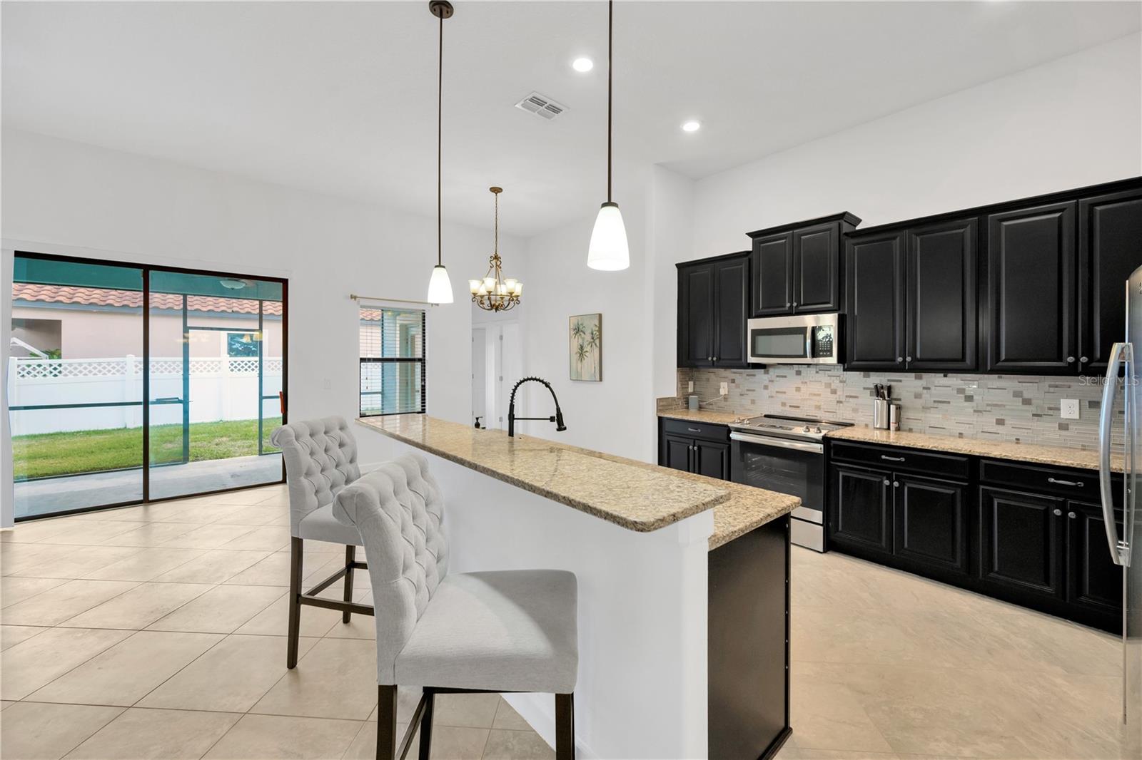 This breakfast bar and kitchen island is the perfect gathering spot with open sight lines to the family room and the living room.