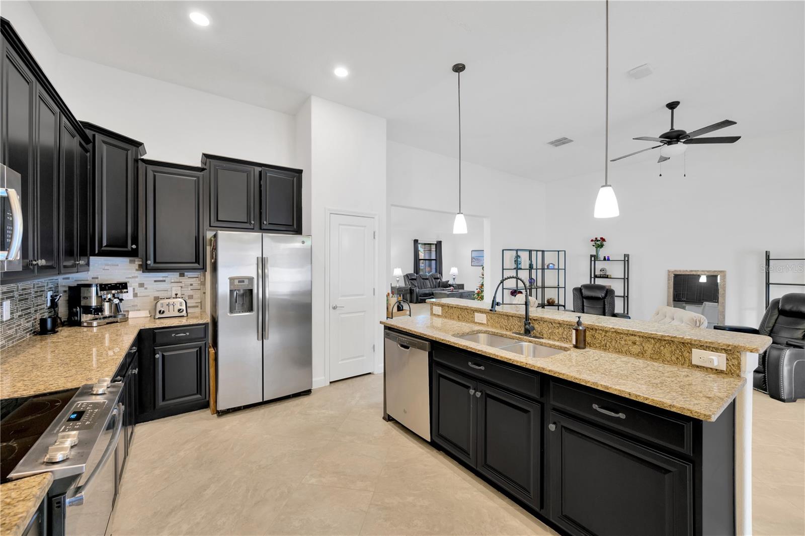 This breakfast bar and kitchen island is the perfect gathering spot with open sight lines to the family room and the living room.