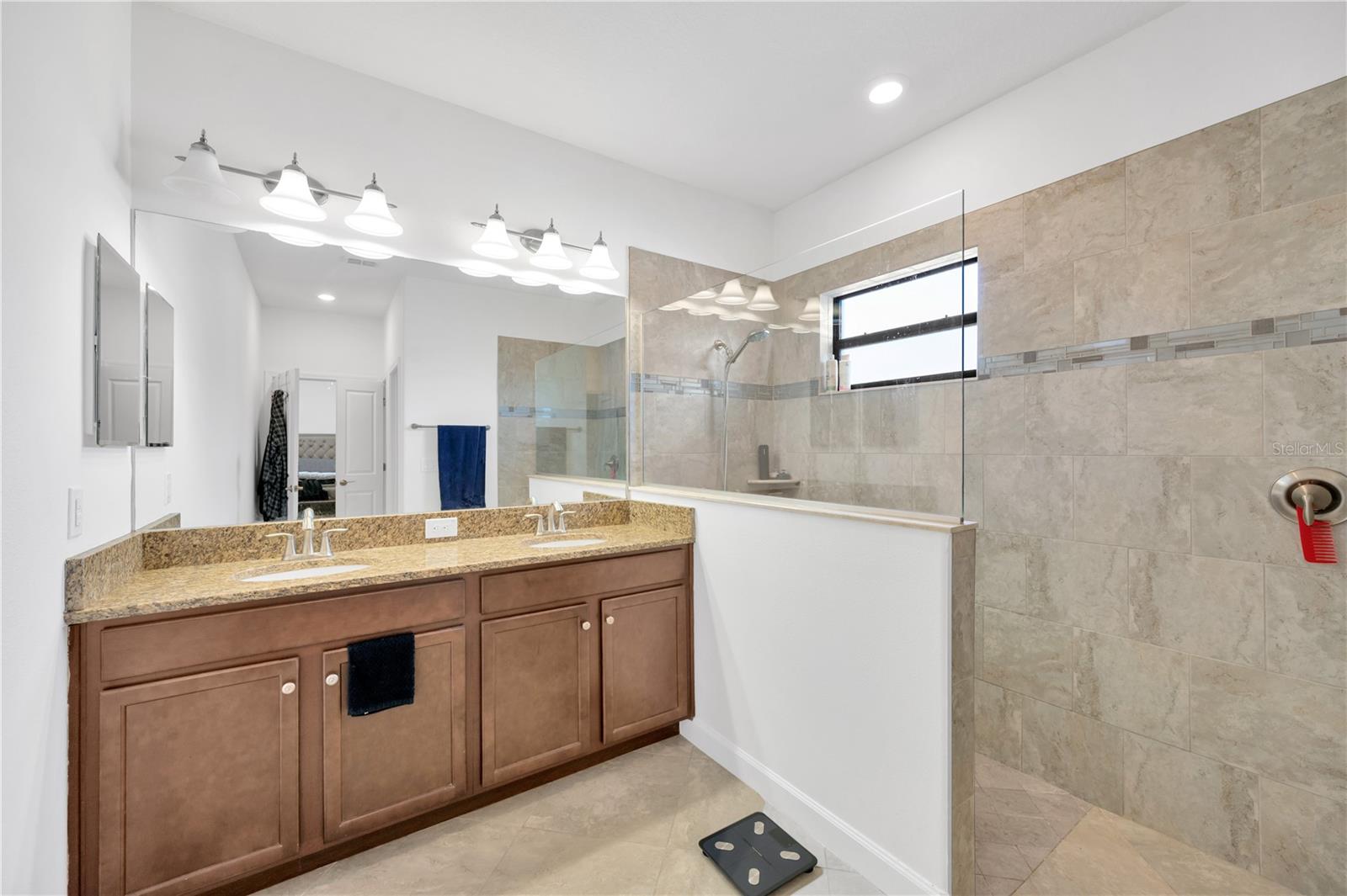 The En Suite has dual sinks on a granite clad vanity, a spacious walk-in shower and a separate water closet.