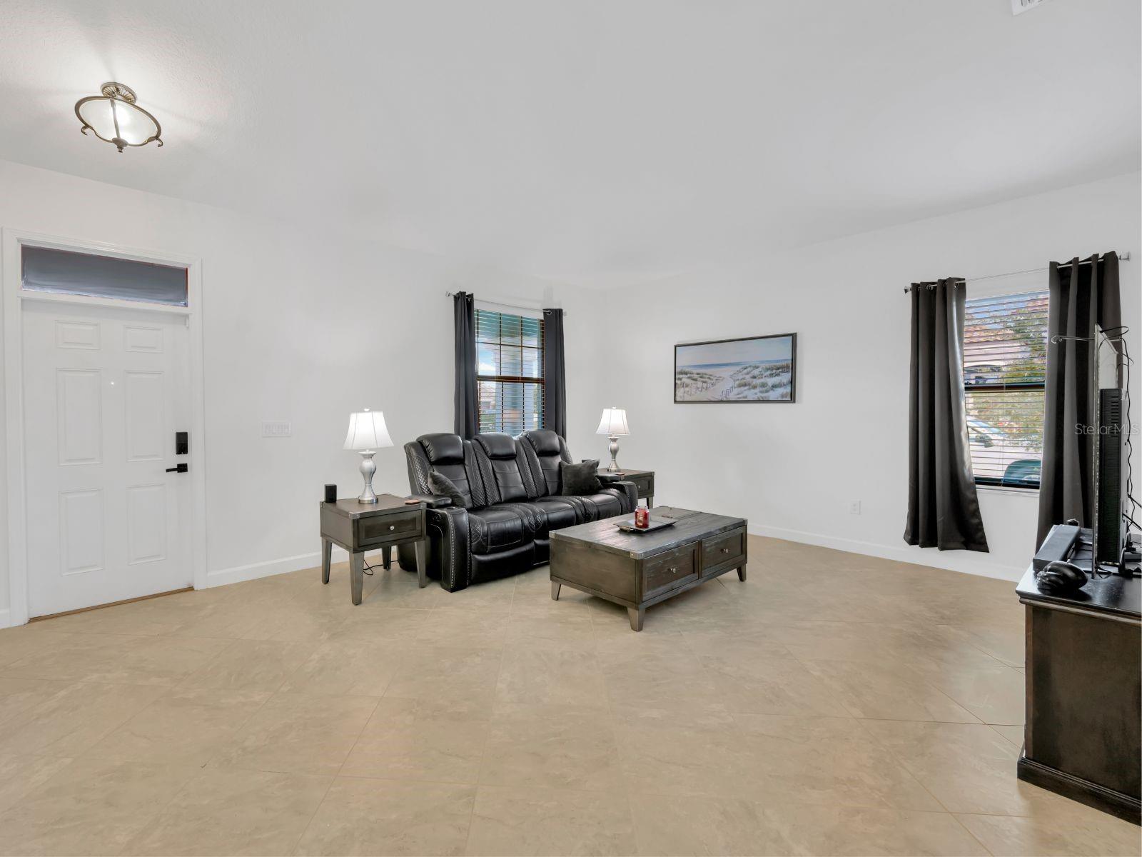 Living room is spacious with high quality tile installed in a diagonal arrangement to bring unique character and visual interest.