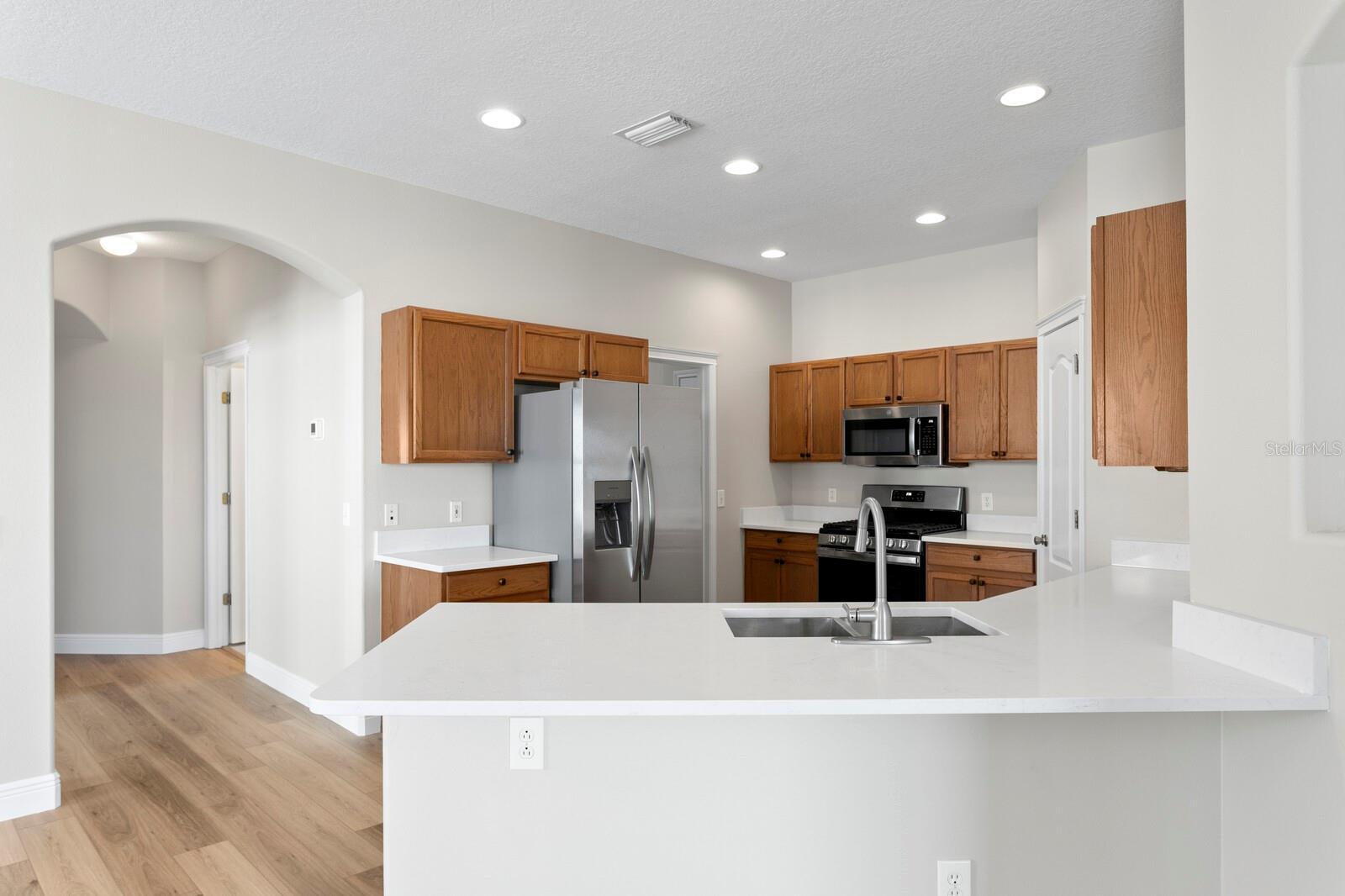 You'll find brand new quartz counters and a breakfast bar in the kitchen