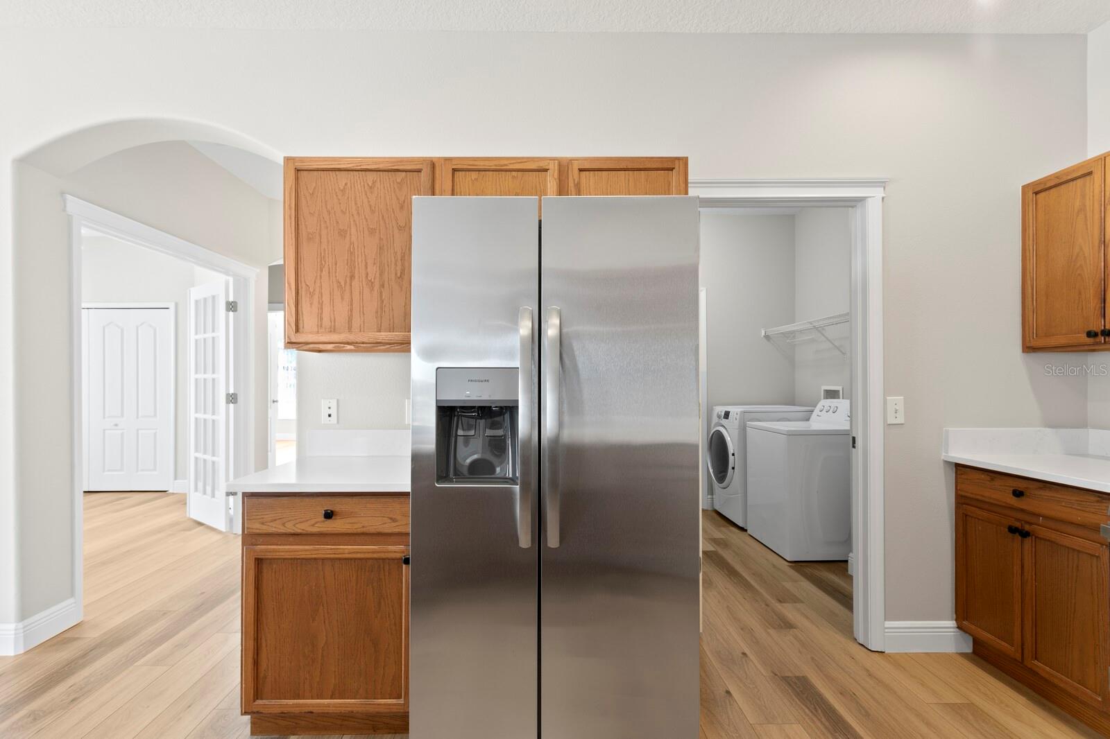 The kitchen includes brand new stainless appliances