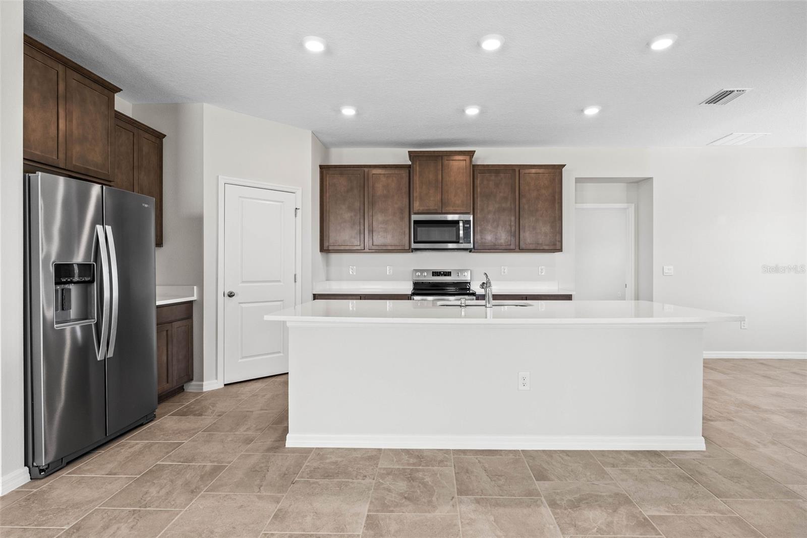 Kitchen has quartz countertops, stainless steel appliance package.