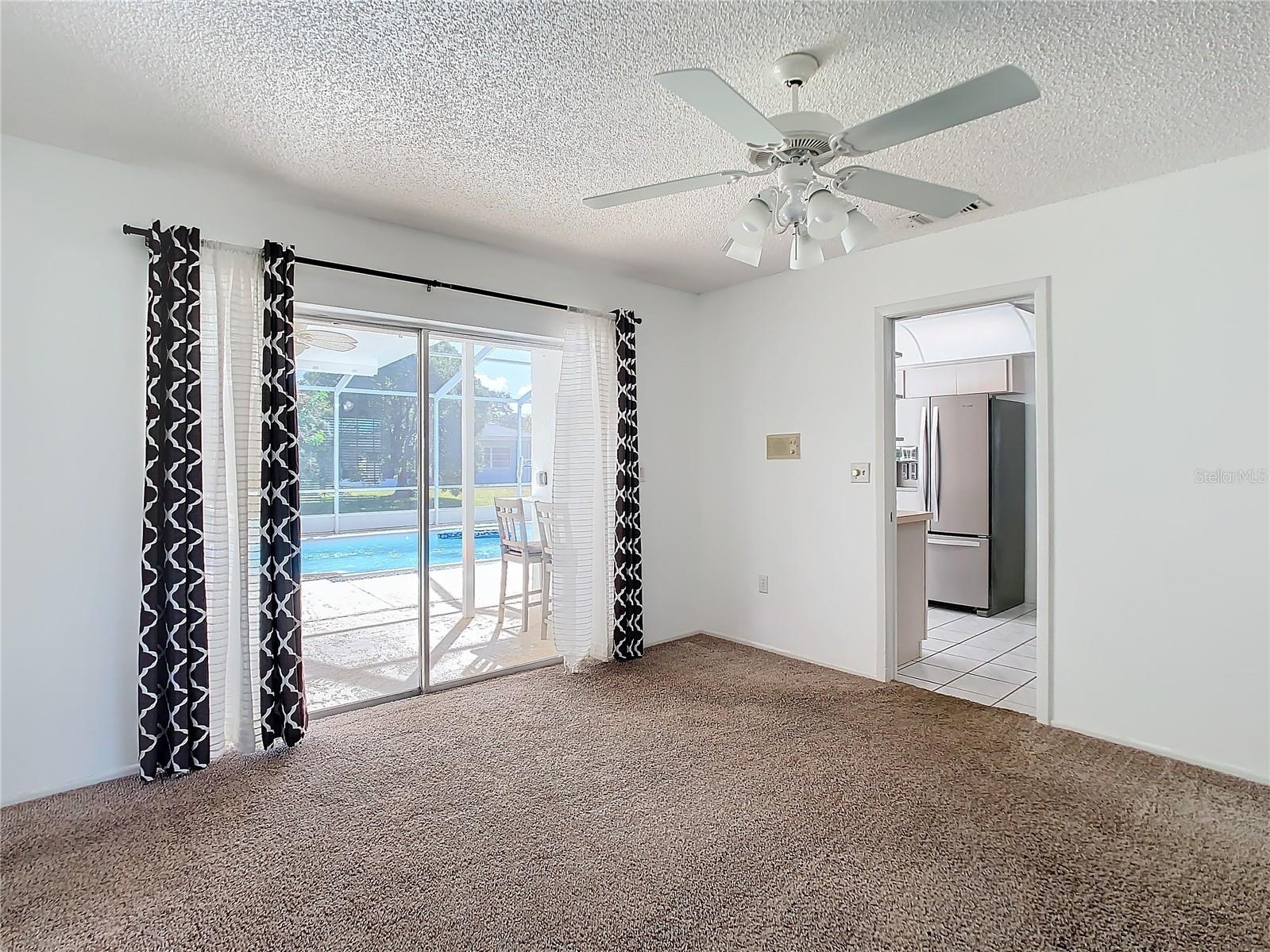 Dining Area with Pool View opens into the Kitchen