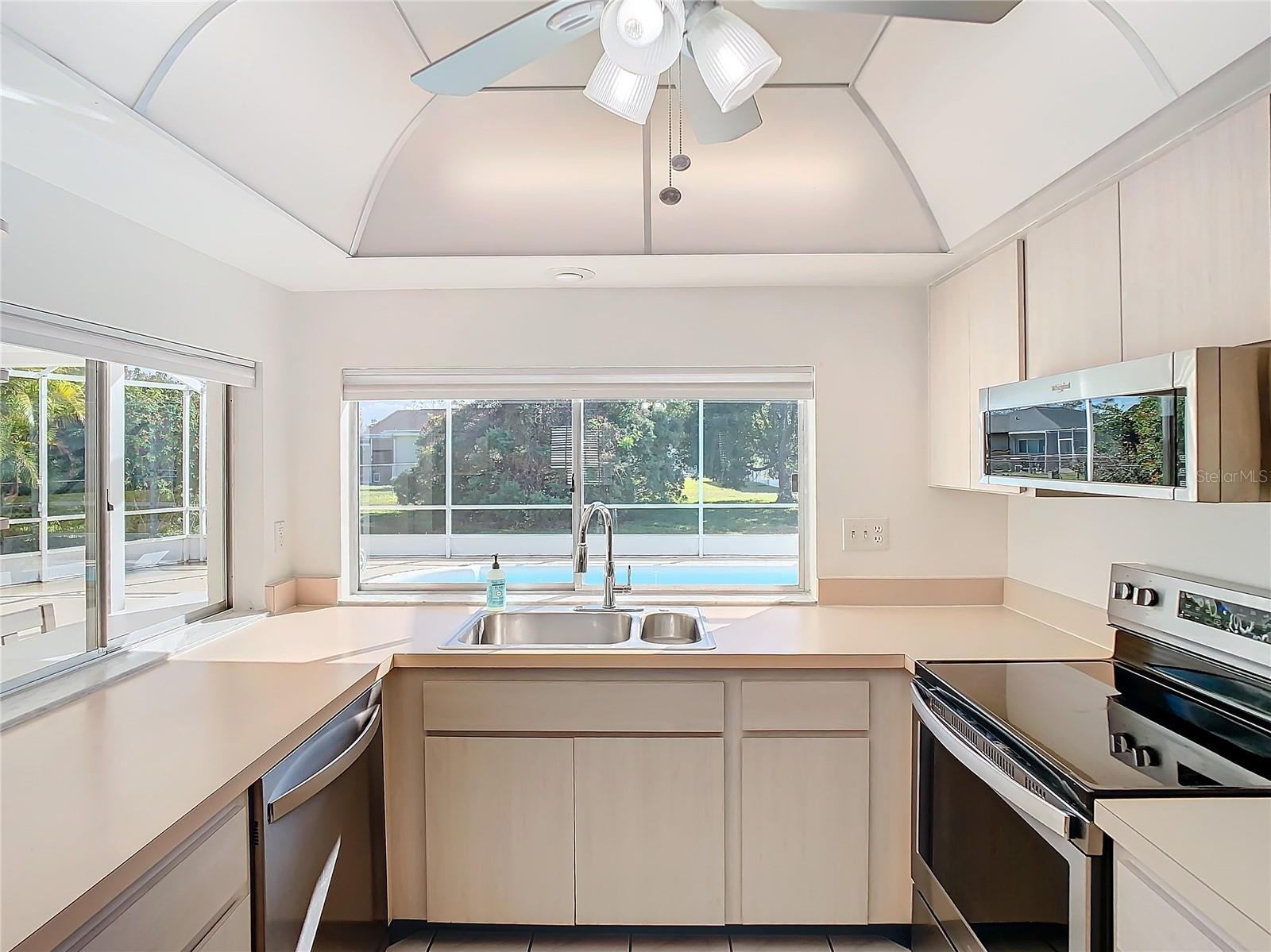 Kitchen with view to the Pool and Pass through to the Breakfast Bar on Lanai