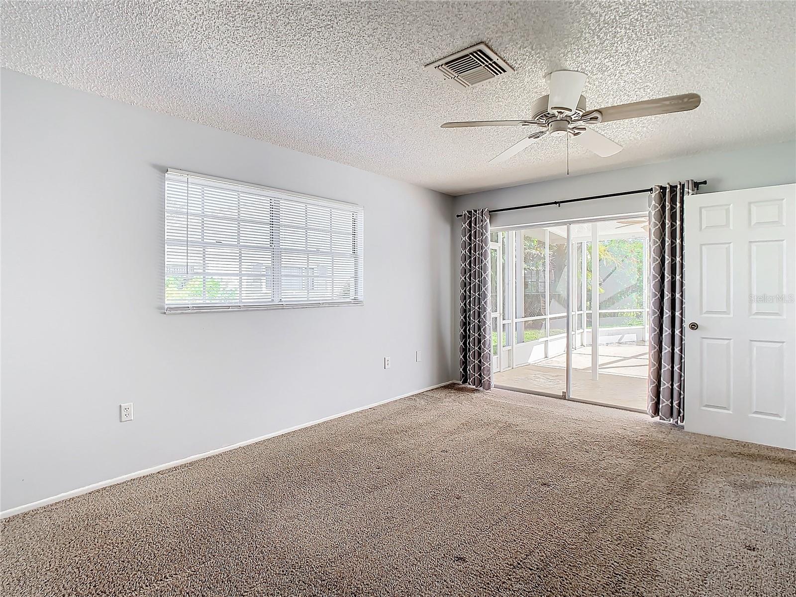 Master Bedroom with Sliders leading to Lanai and Pool