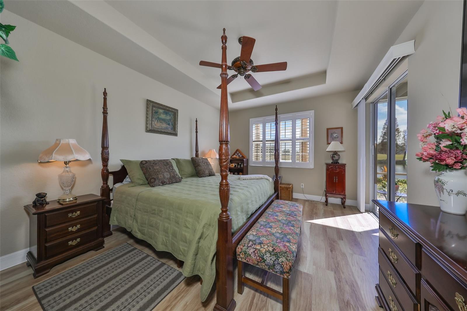 The master bedroom is luxurious and comfortable.  With high ceilings, custom fan and engineered wood flooring make this a perfect get away from the hustle and bustle.