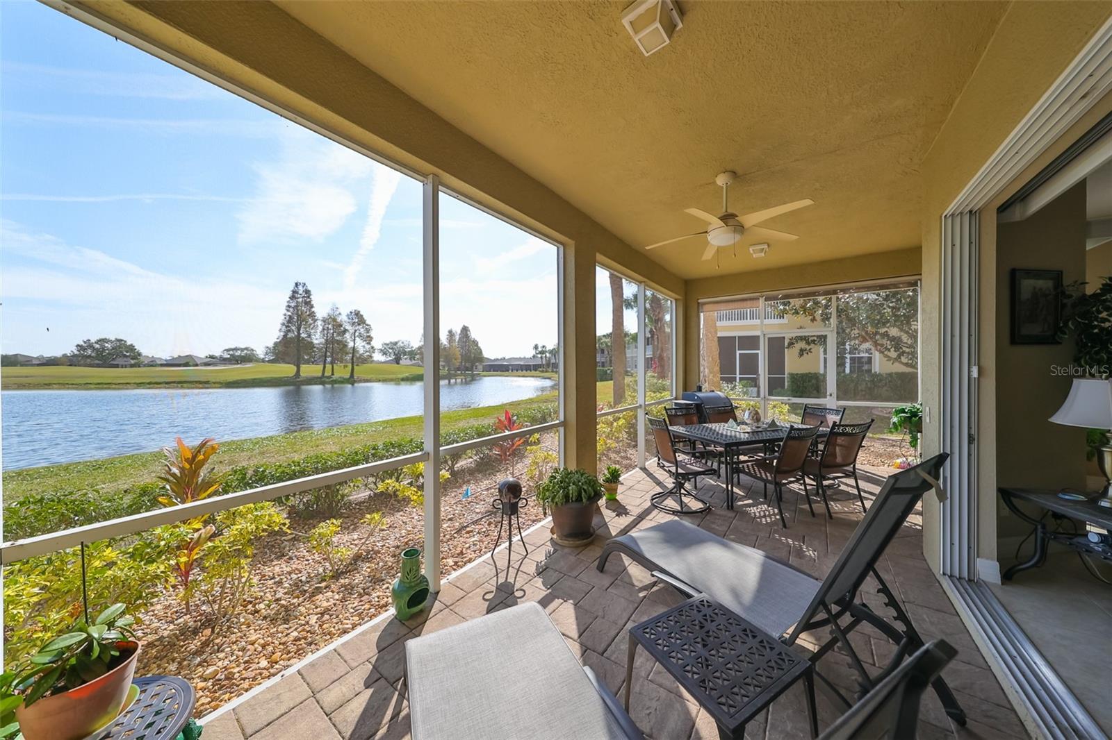 Beautiful pavered flooring, ceiling fans, shade screen for privacy at the far end and a stunning water view.