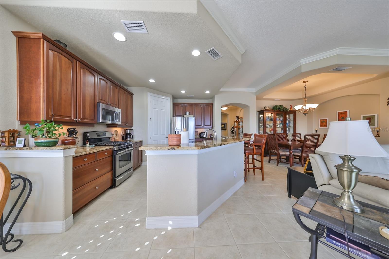 The kitchen boasts of modern granite, custom 42" wood cabinetry and stainless steel appliances with a huge walk in pantry.