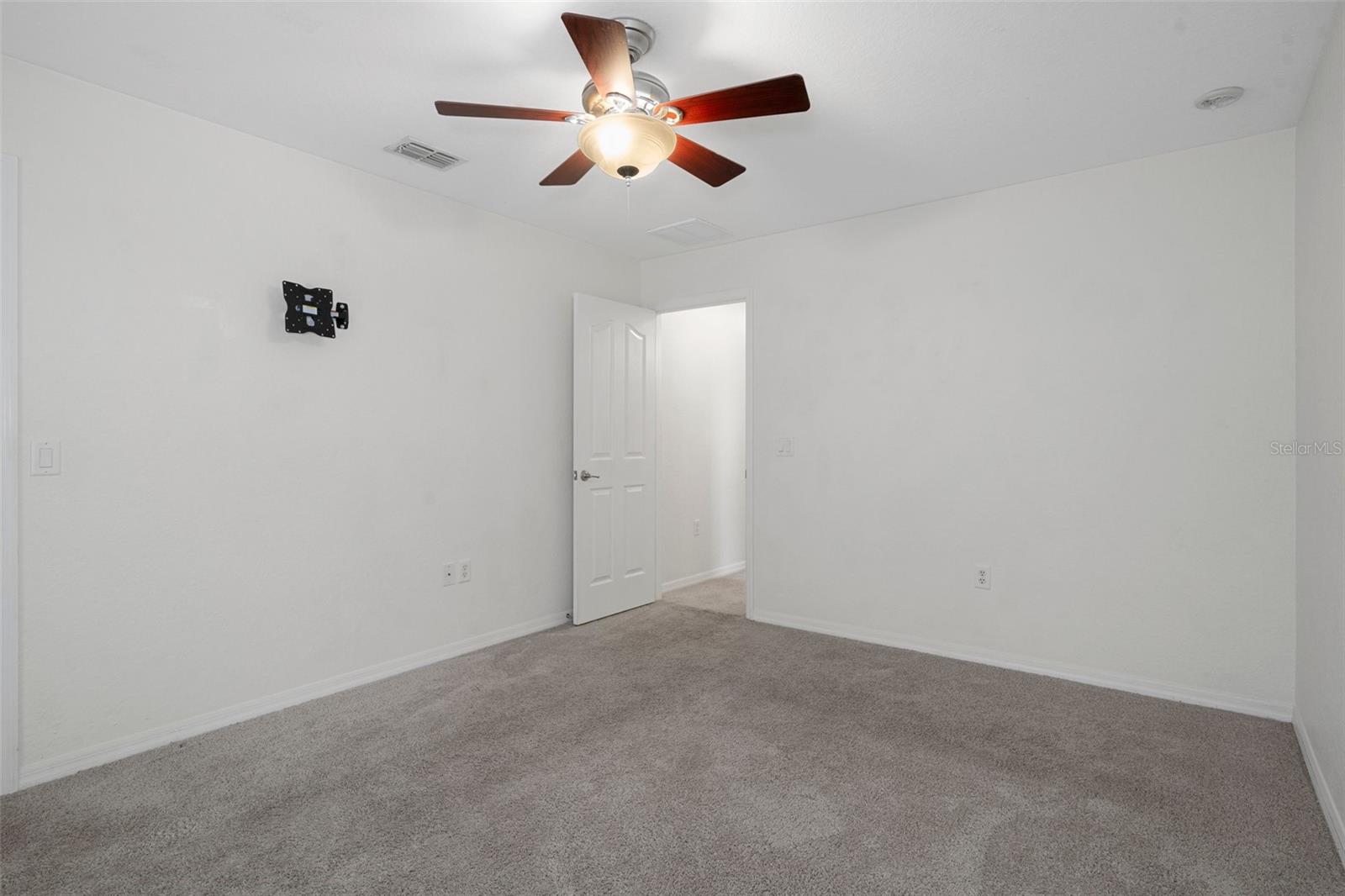 This bedroom has a  fan/light