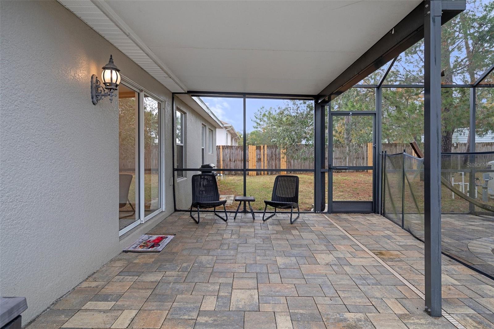 The Screened In Pool Area has Gorgeous Pavers