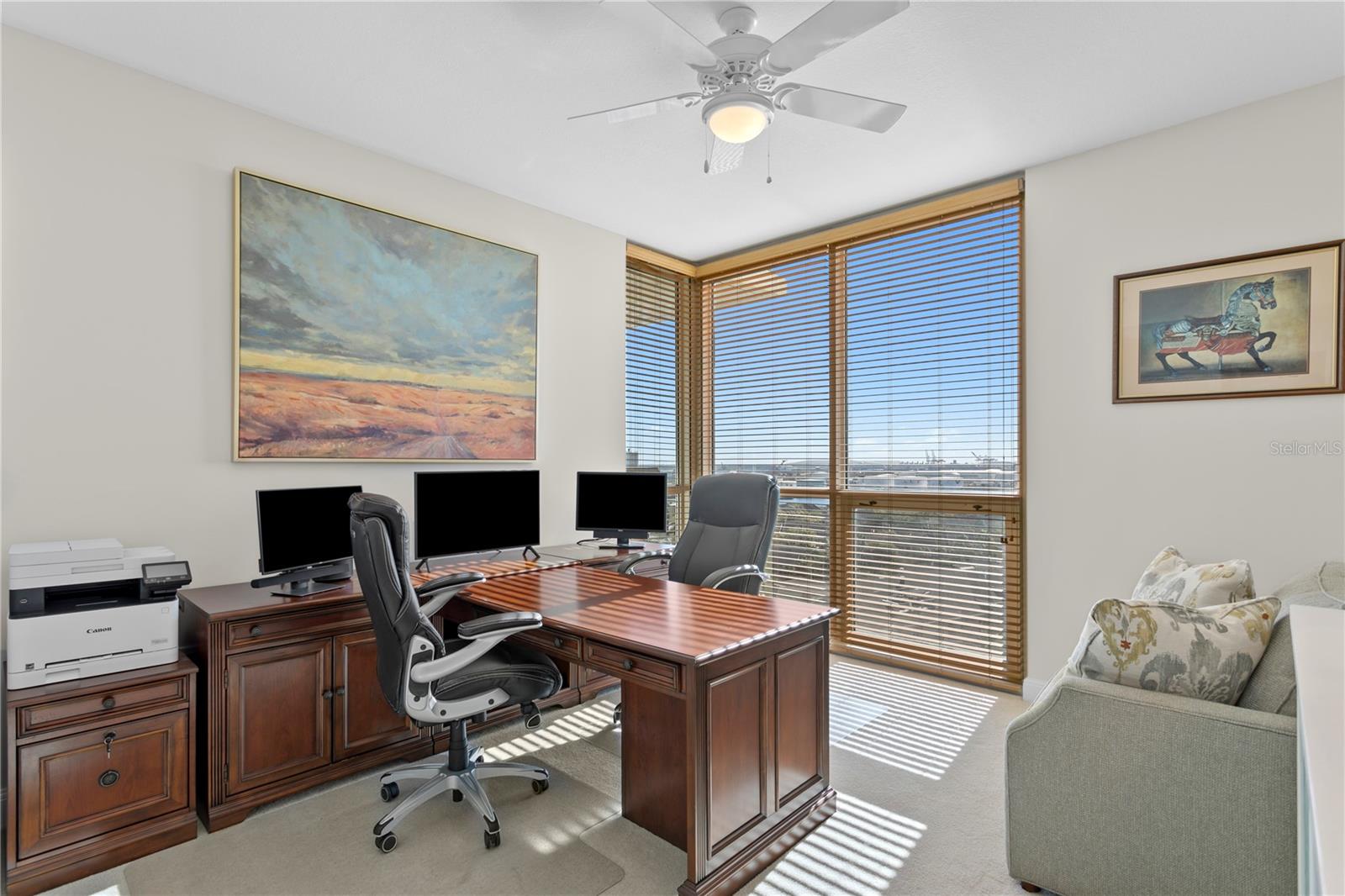 Bedroom #3 is currently used as office with a partner's desk. Notice the floor to ceiling windows