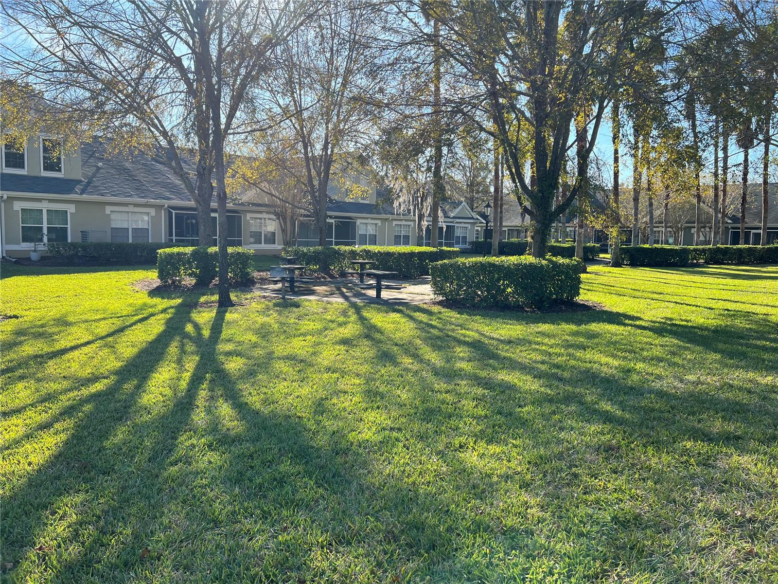 Outdoor grilling area with picnic tables