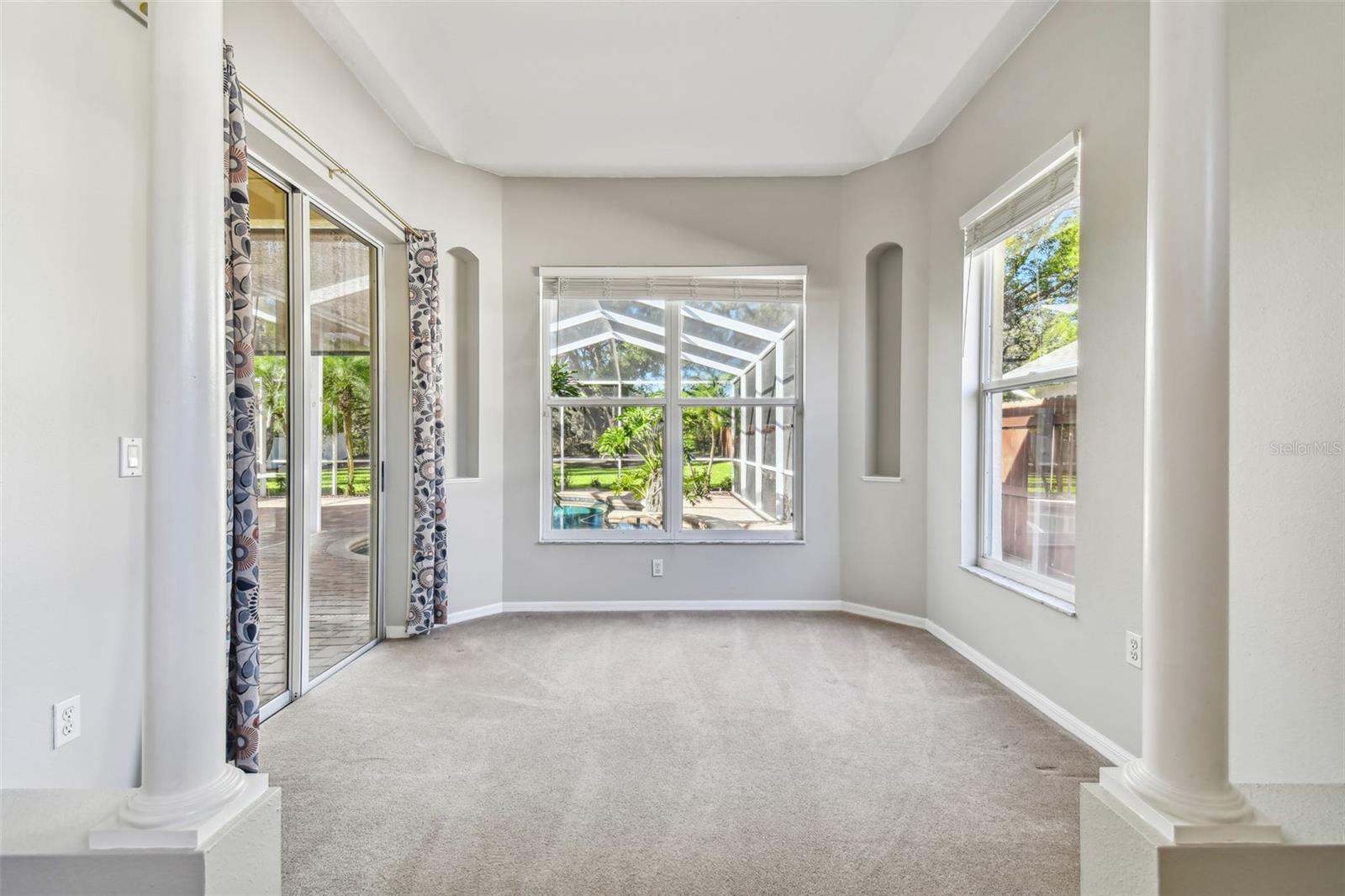 This sitting area is a perfect spot to read a book or simply unwind.  The sliders lead out to the pool/spa area for easy access from the primary bedroom.